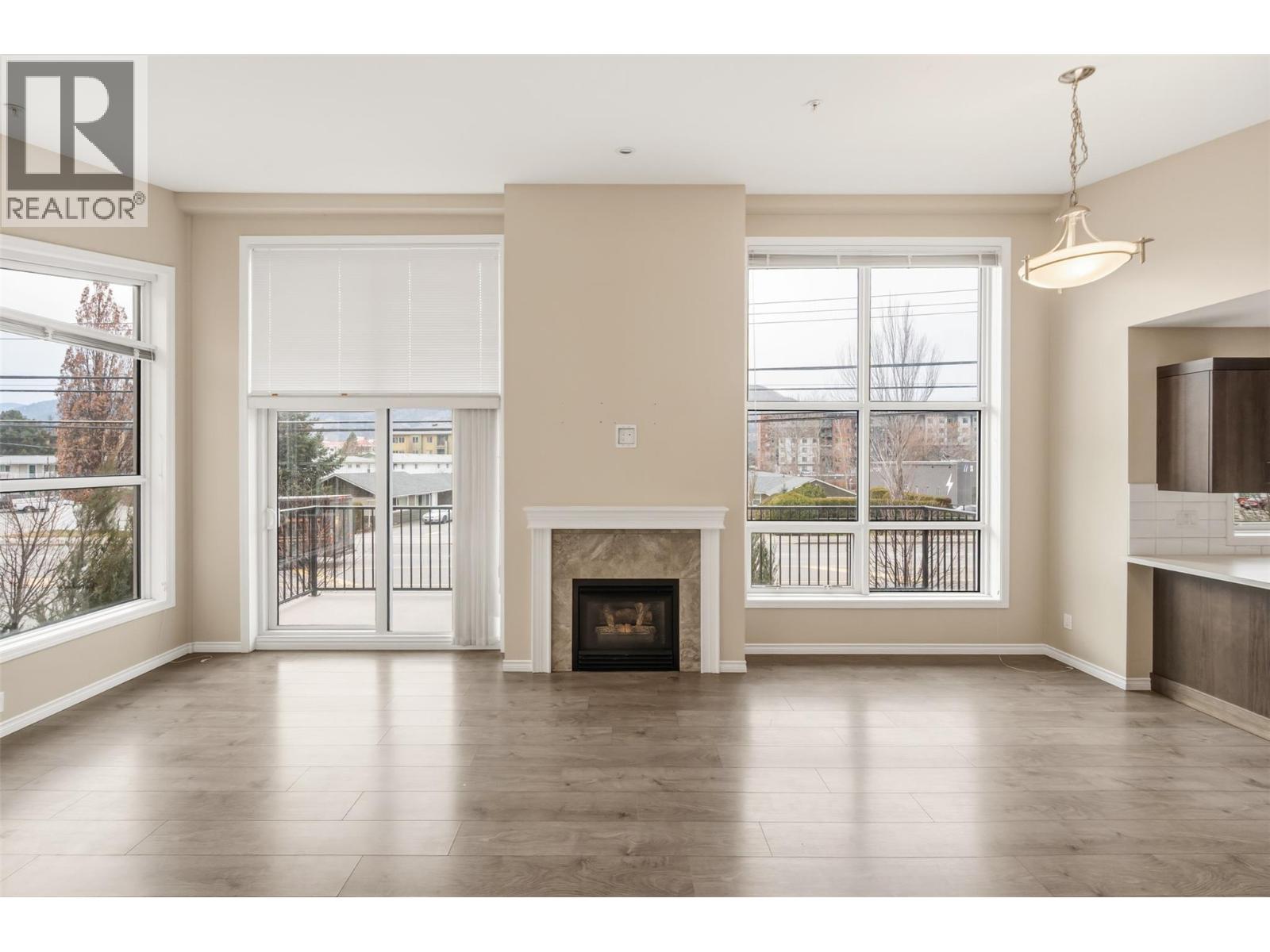 201 3388 Skaha Lake Road, Penticton — living room with fireplace