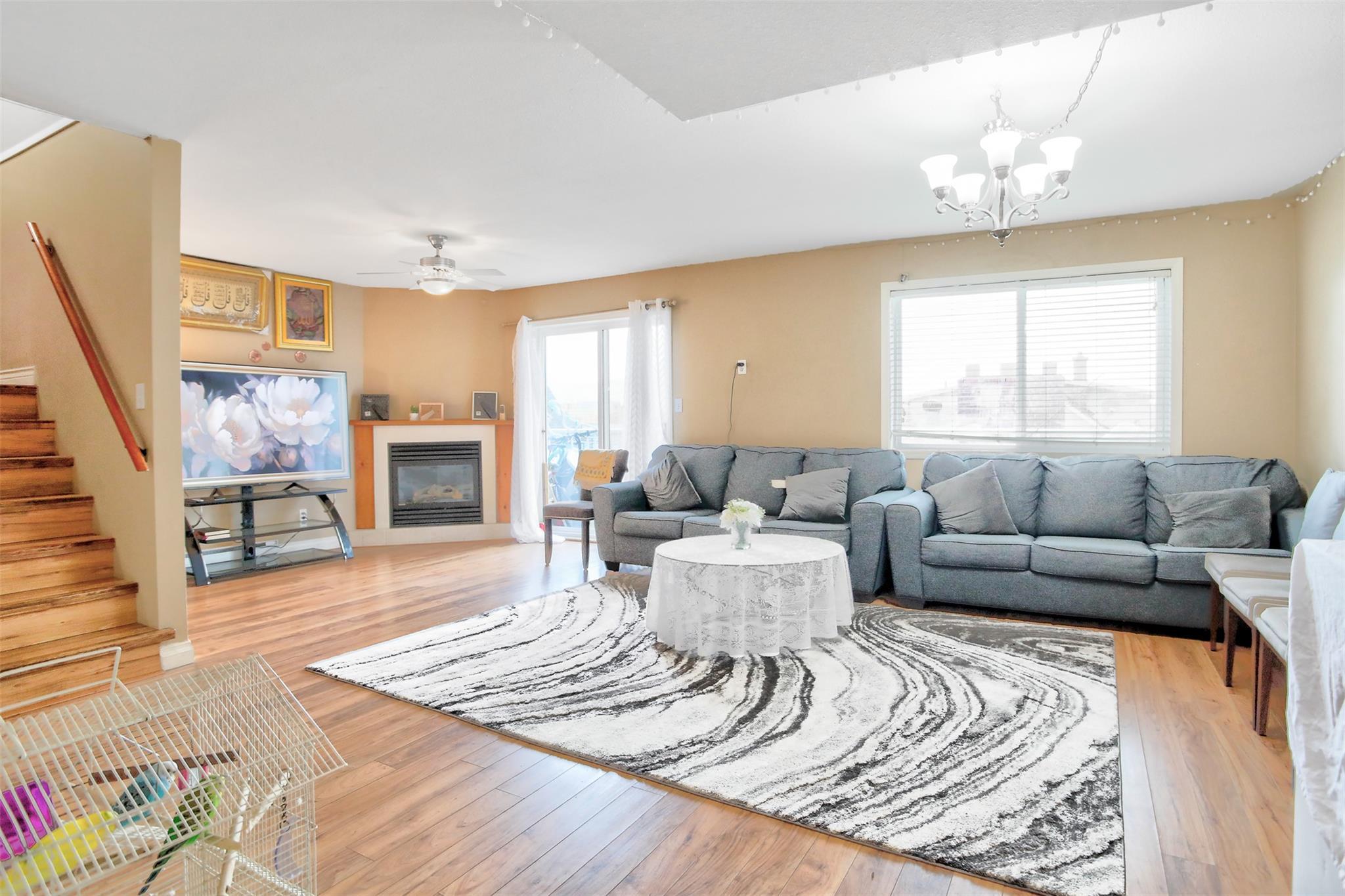 Living room with gas fireplace and stairway in Unit 203 at Eckhardt Manor.