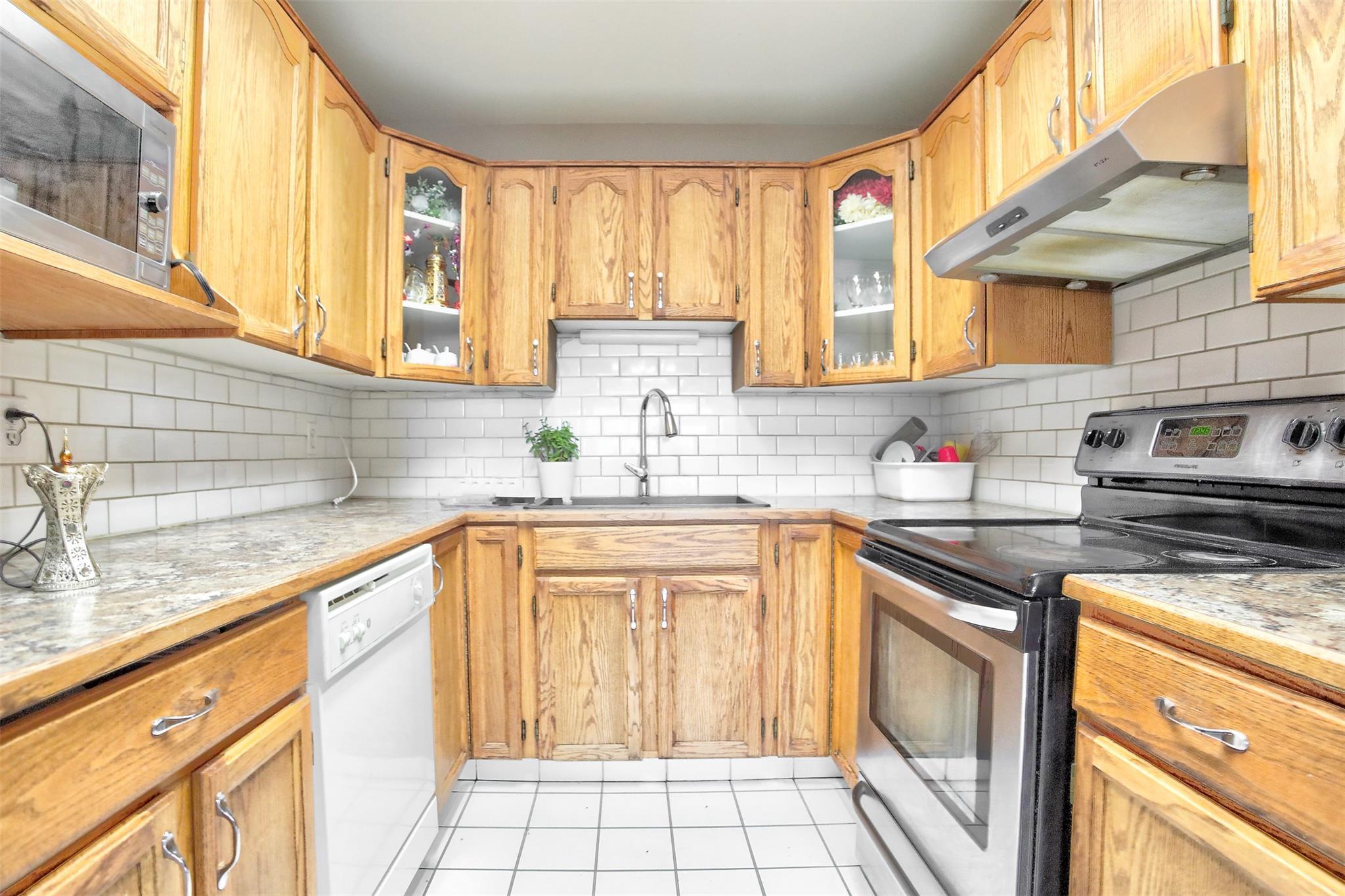 Wood kitchen with stainless appliances in Unit 203 at 95 Eckhardt Avenue East.