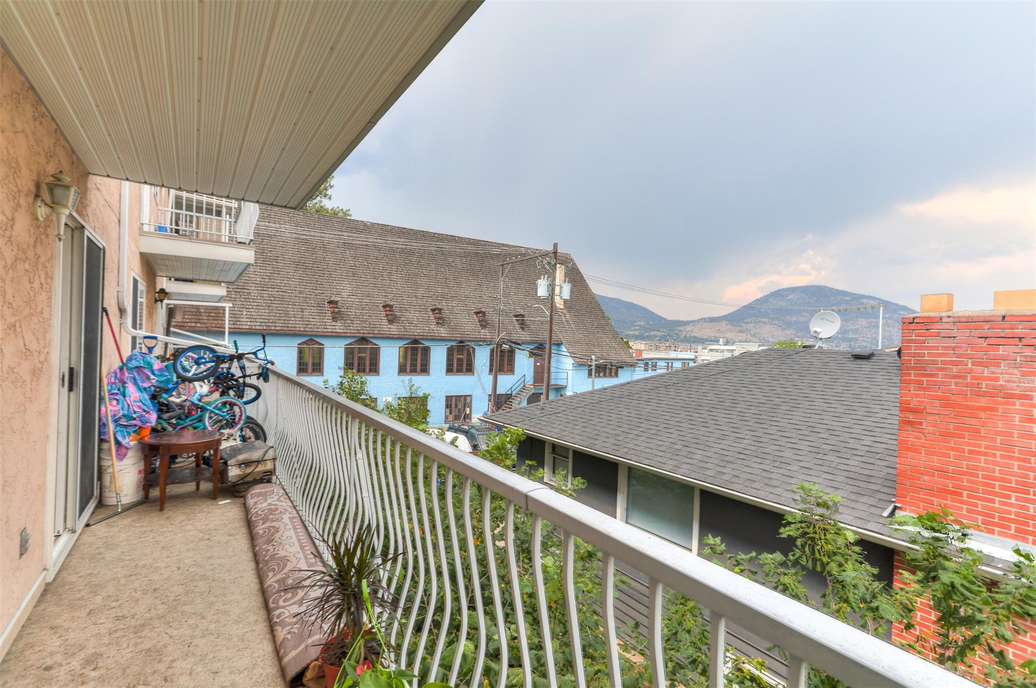 Covered balcony with mountain outlook at Unit 203 in Eckhardt Manor.