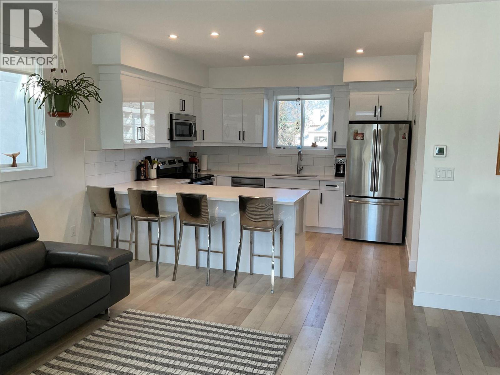 Unit 104 at 210 Scott Avenue, Penticton — open kitchen and living area