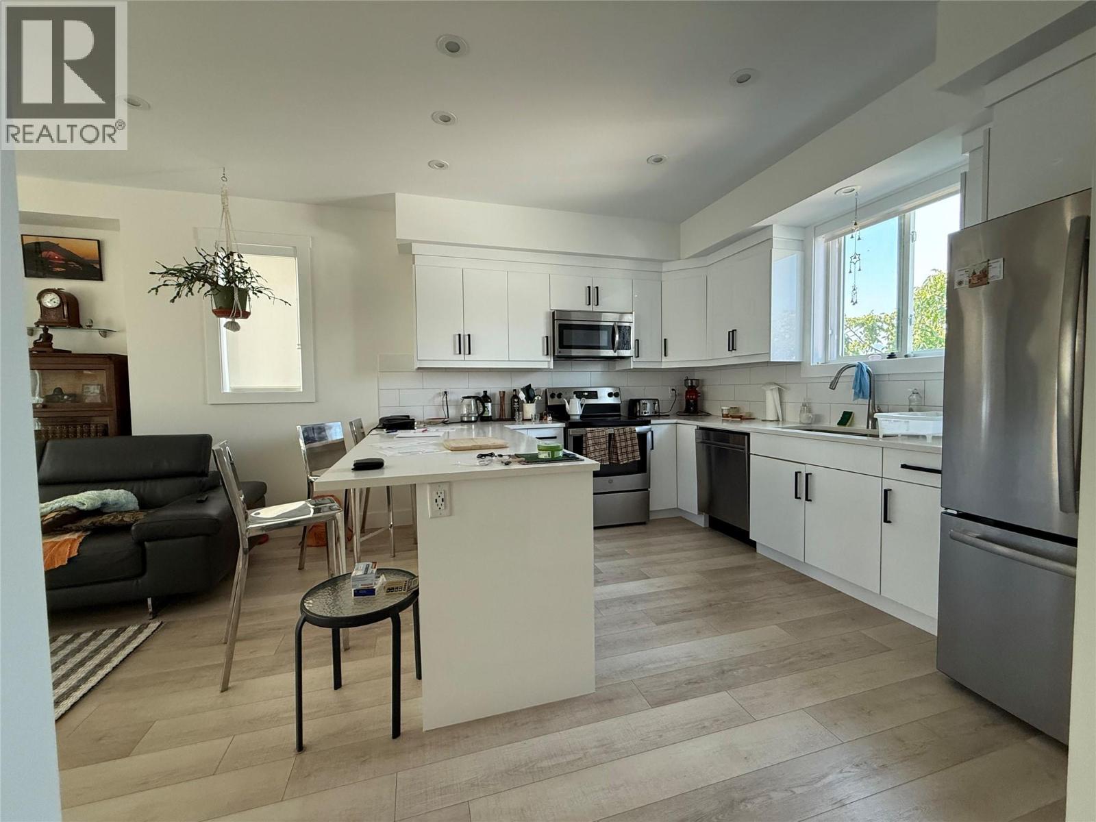 Unit 104 at 210 Scott Avenue, Penticton — bright kitchen and island