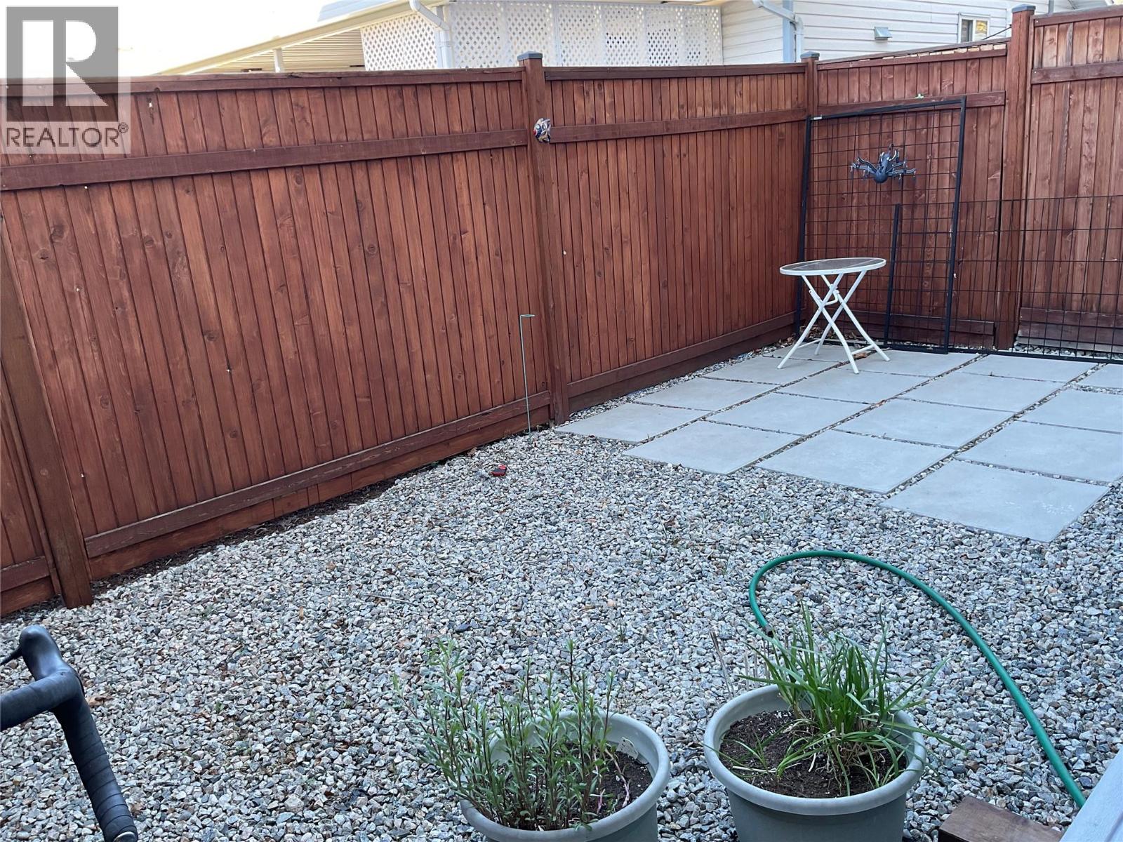 Unit 104 at 210 Scott Avenue, Penticton — private fenced patio