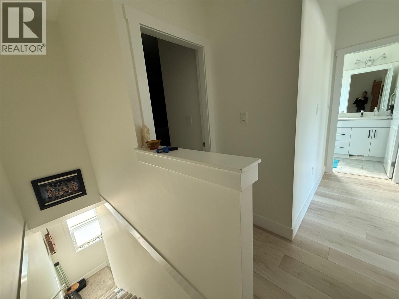 Unit 104 at 210 Scott Avenue, Penticton — upper landing and stairwell