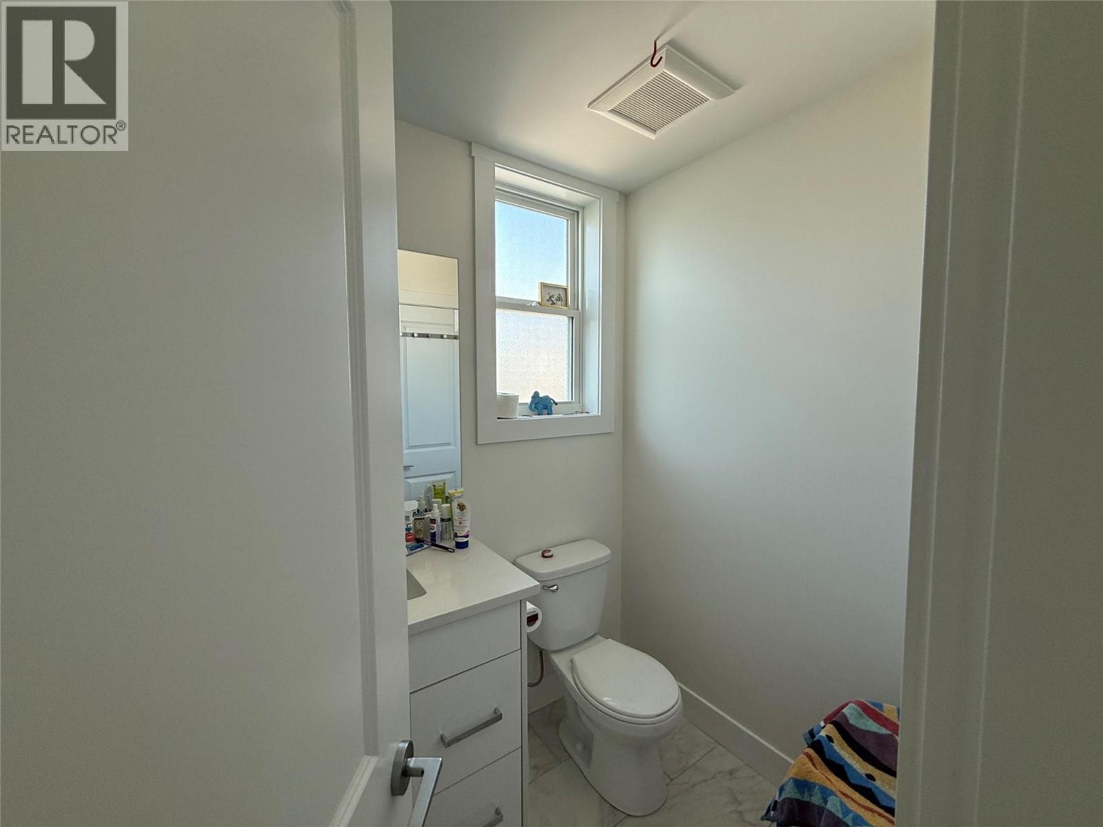Unit 104 at 210 Scott Avenue, Penticton — main-floor powder room