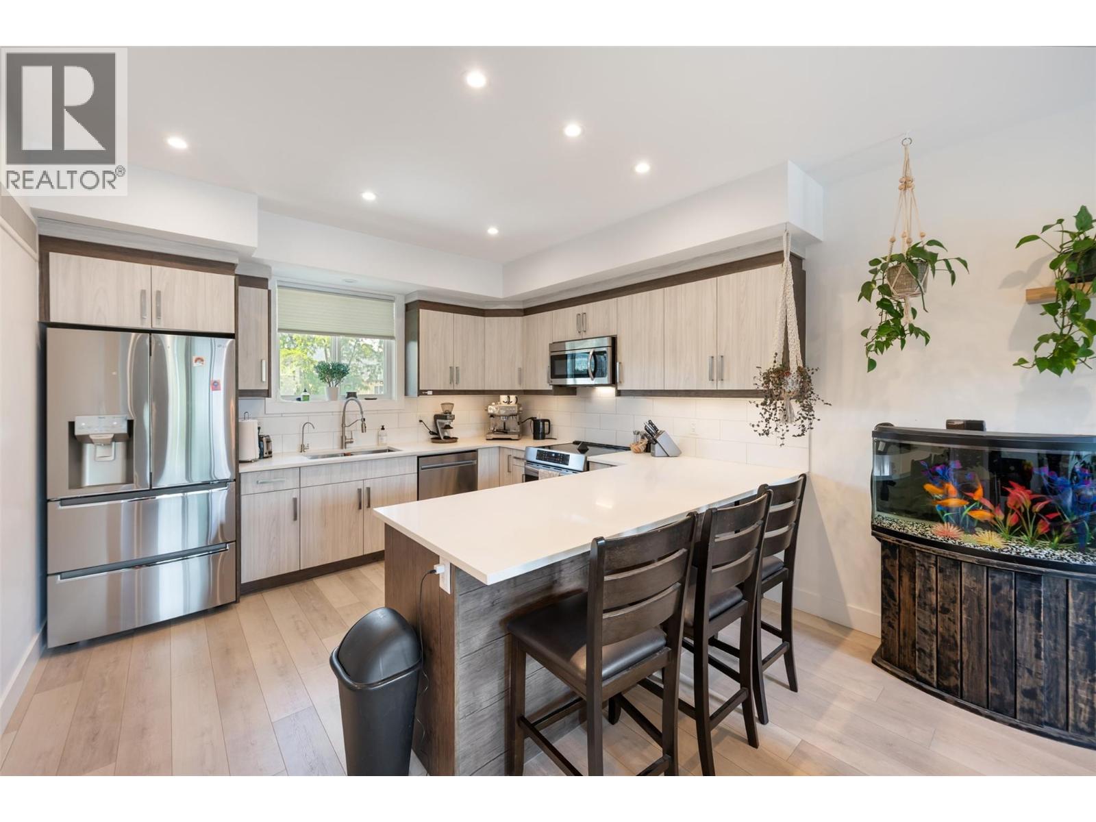 Unit 107 at 210 Scott Avenue, Penticton — open kitchen and island