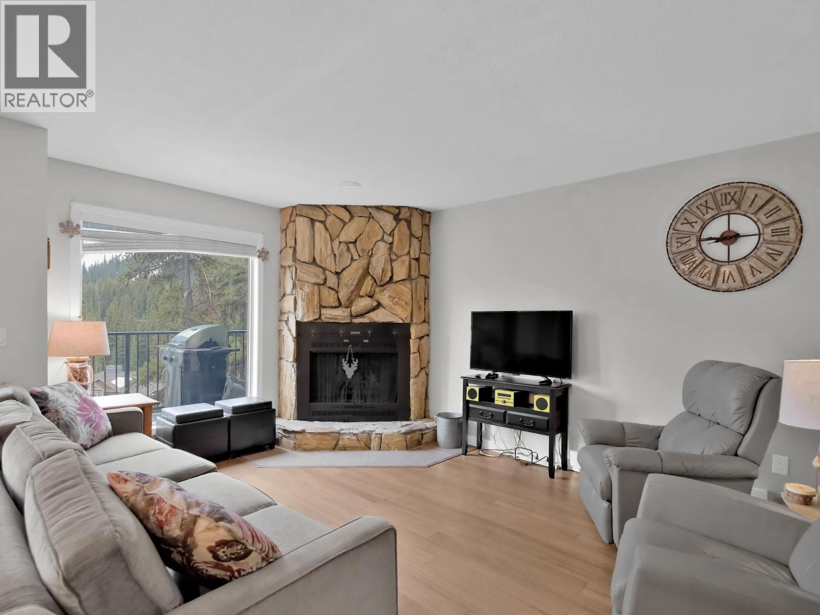 225 Clearview Road Unit 903 — living room with stone fireplace
