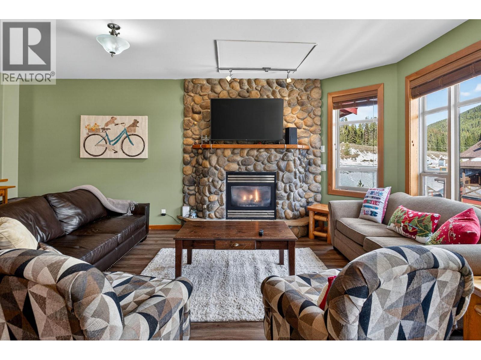 360 Strayhorse Road Unit 19 — living room with river-rock fireplace