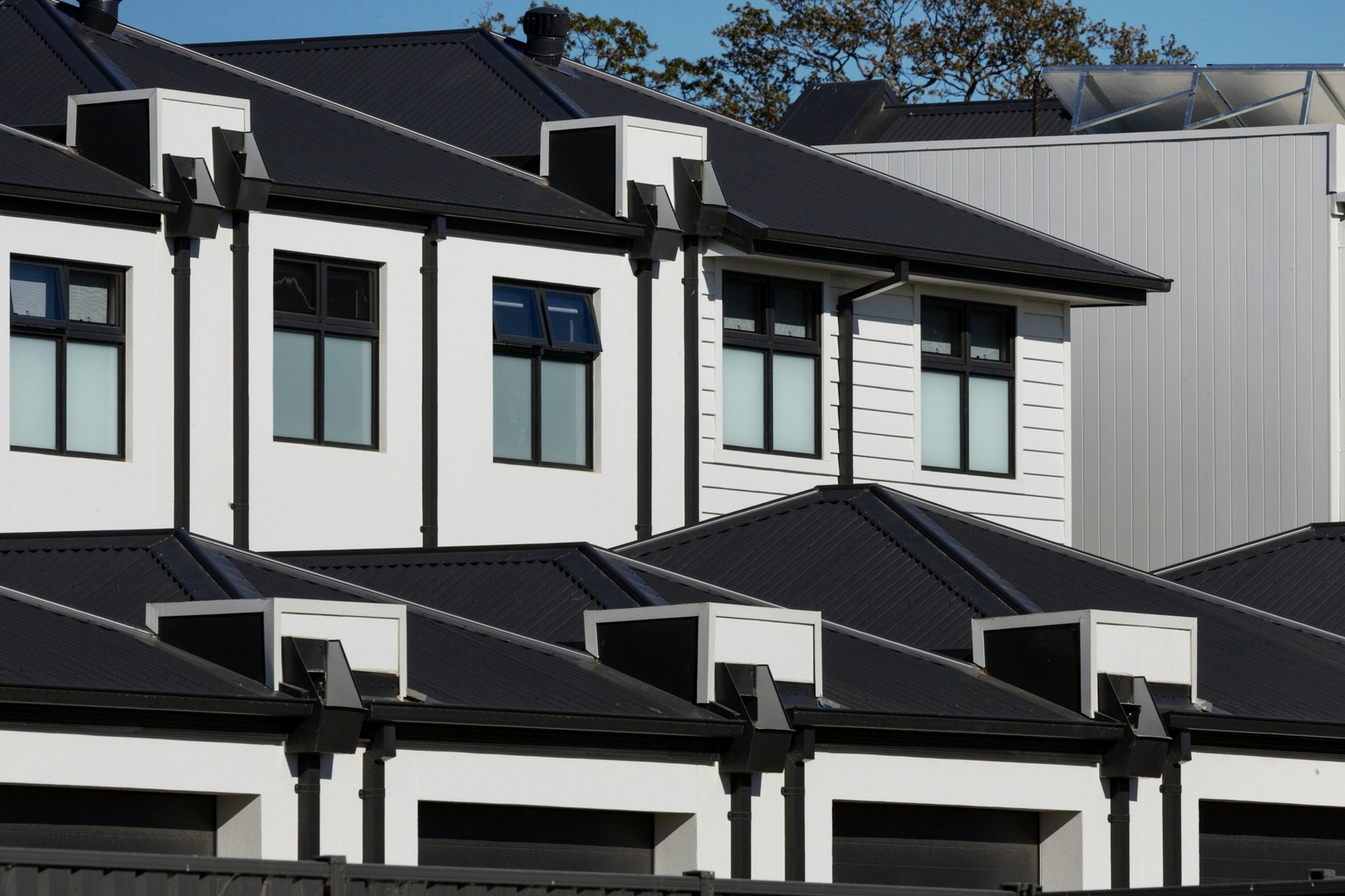 Real modern attached townhomes used as generic editorial imagery for strata-document education