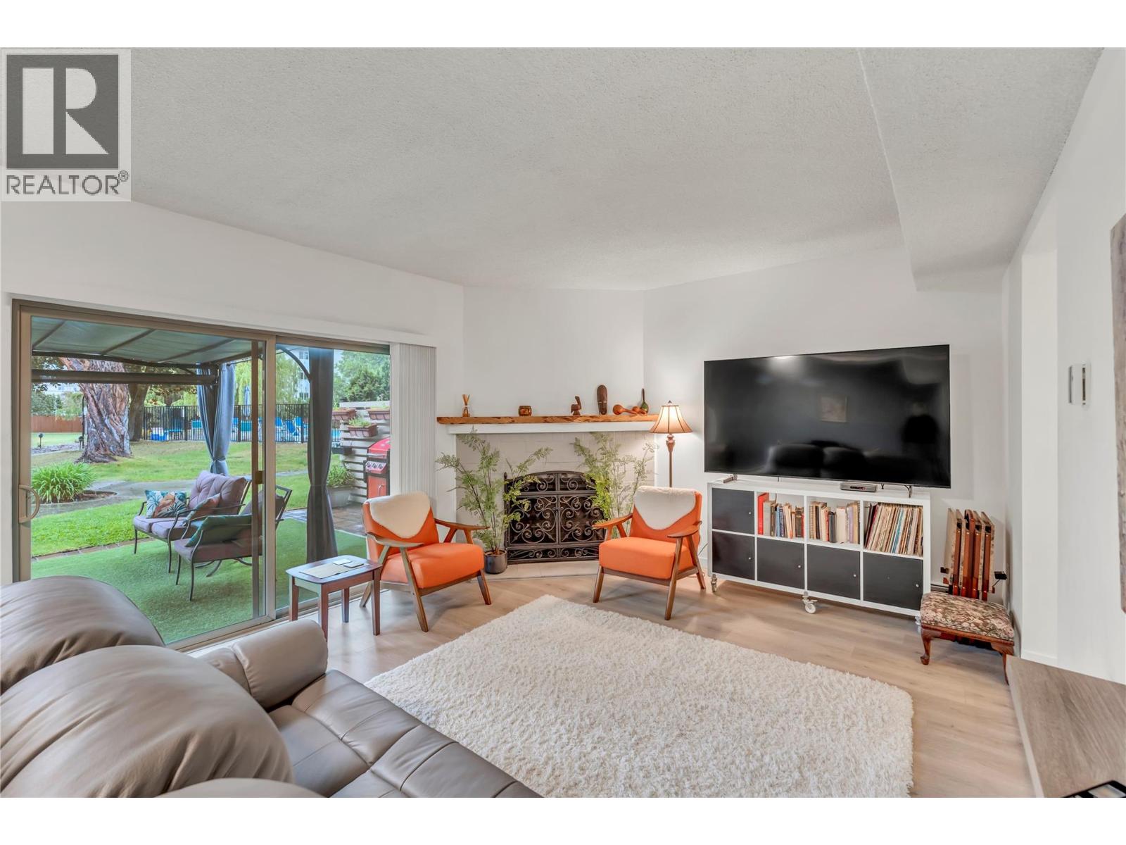 Unit 13 at Skaha Village, 310 Yorkton Avenue, Penticton — sunken living room with patio outlook
