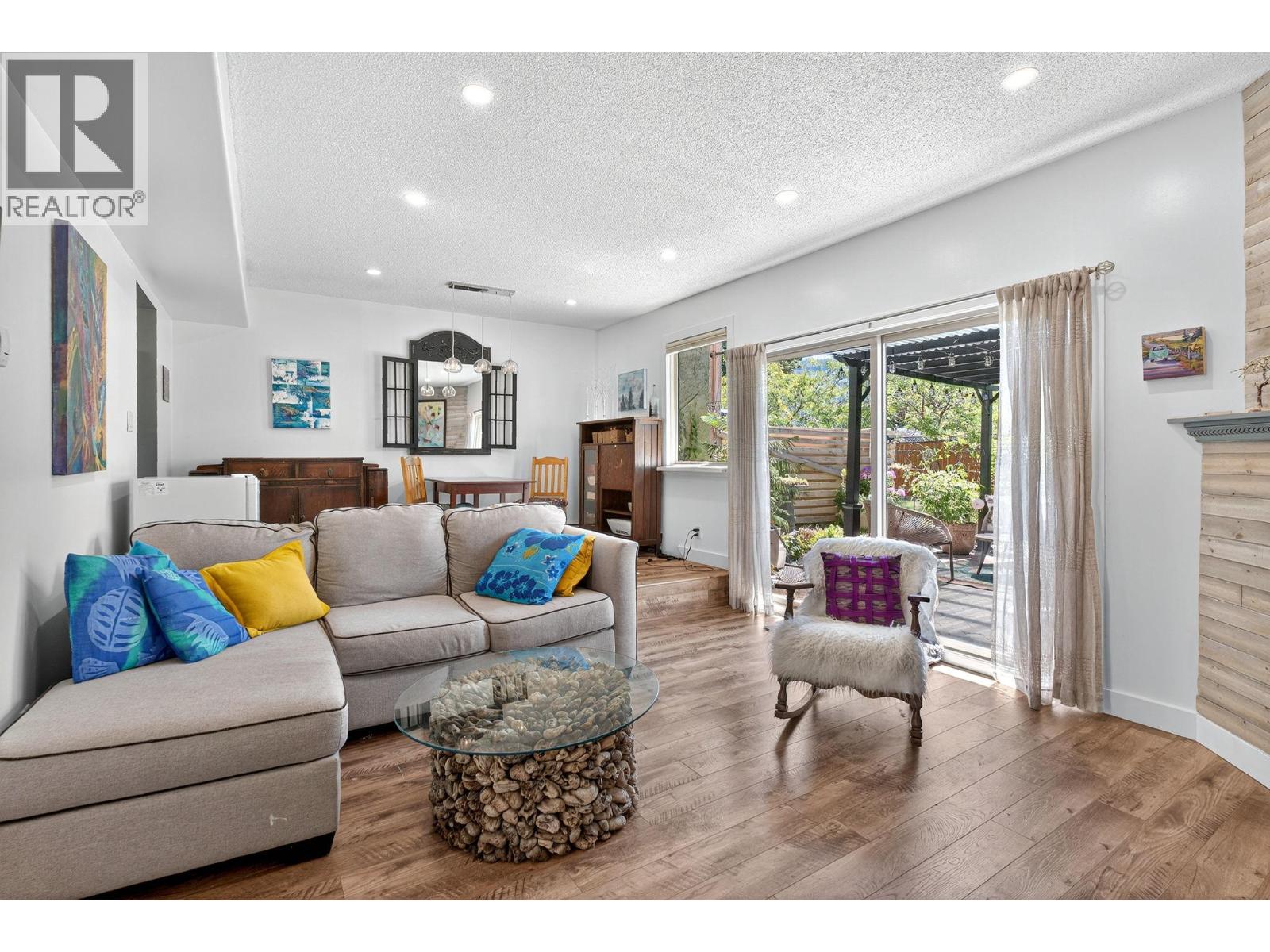 Unit 29 at Skaha Village, 310 Yorkton Avenue, Penticton — bright living room with patio doors