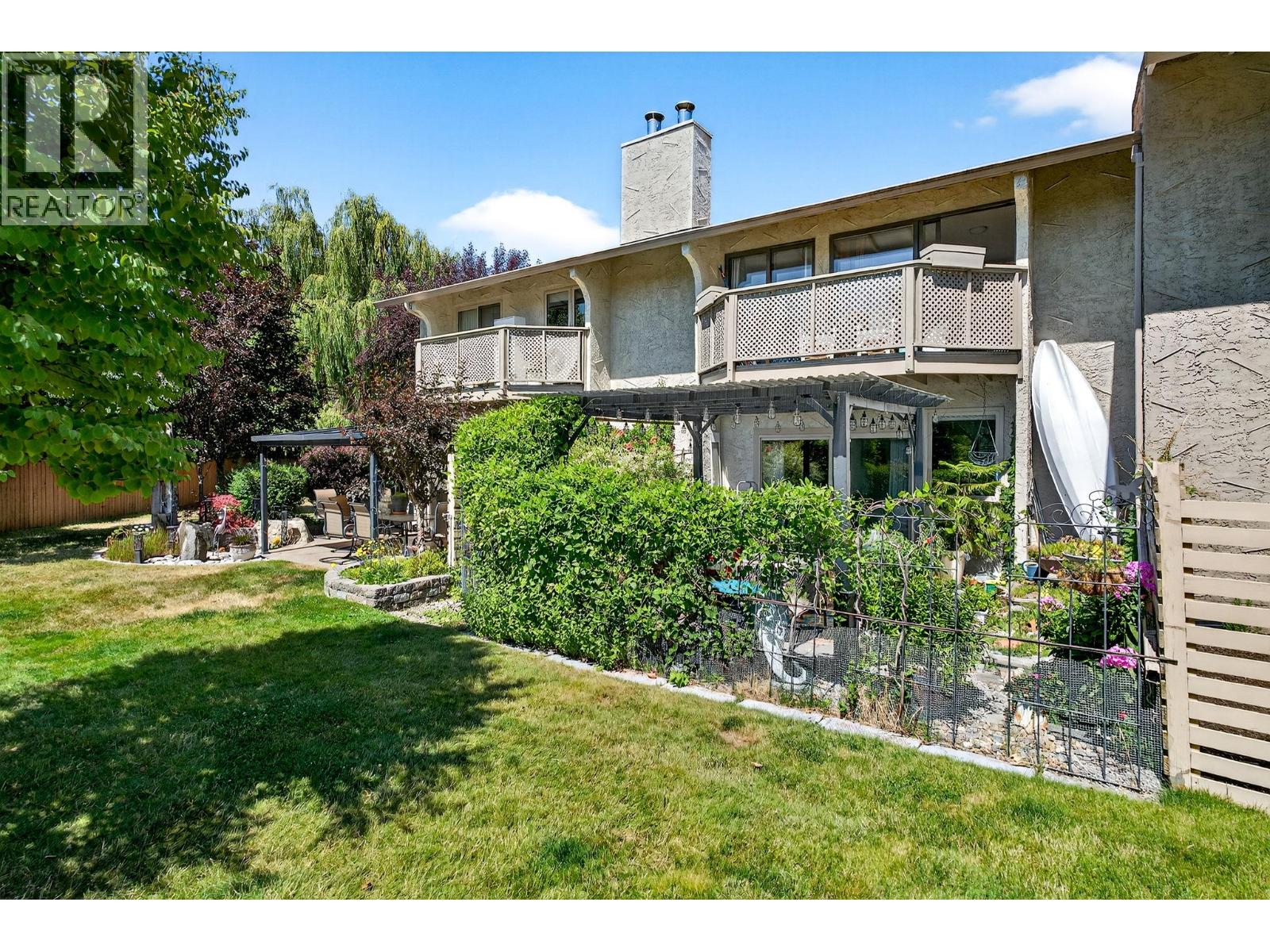 Unit 29 at Skaha Village, 310 Yorkton Avenue, Penticton — rear exterior and landscaped yard