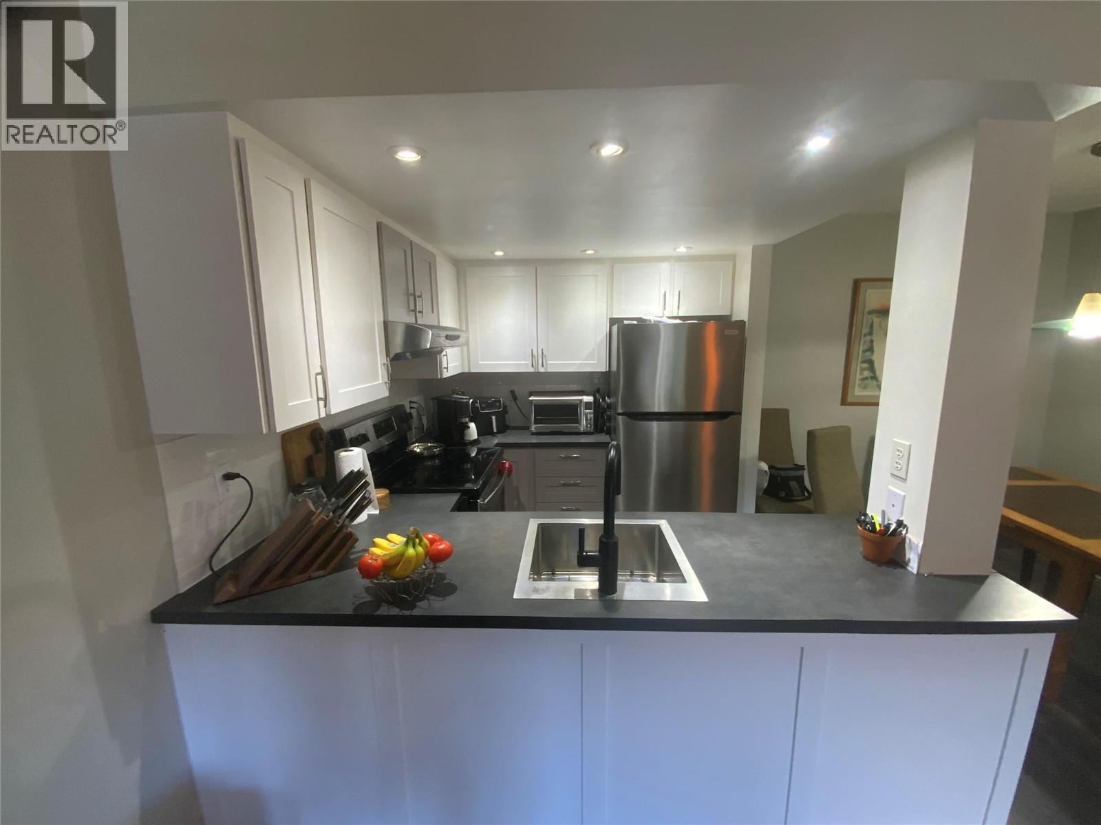 Unit 216 at Tiffany Gardens, 3140 Wilson Street, Penticton — updated kitchen and island