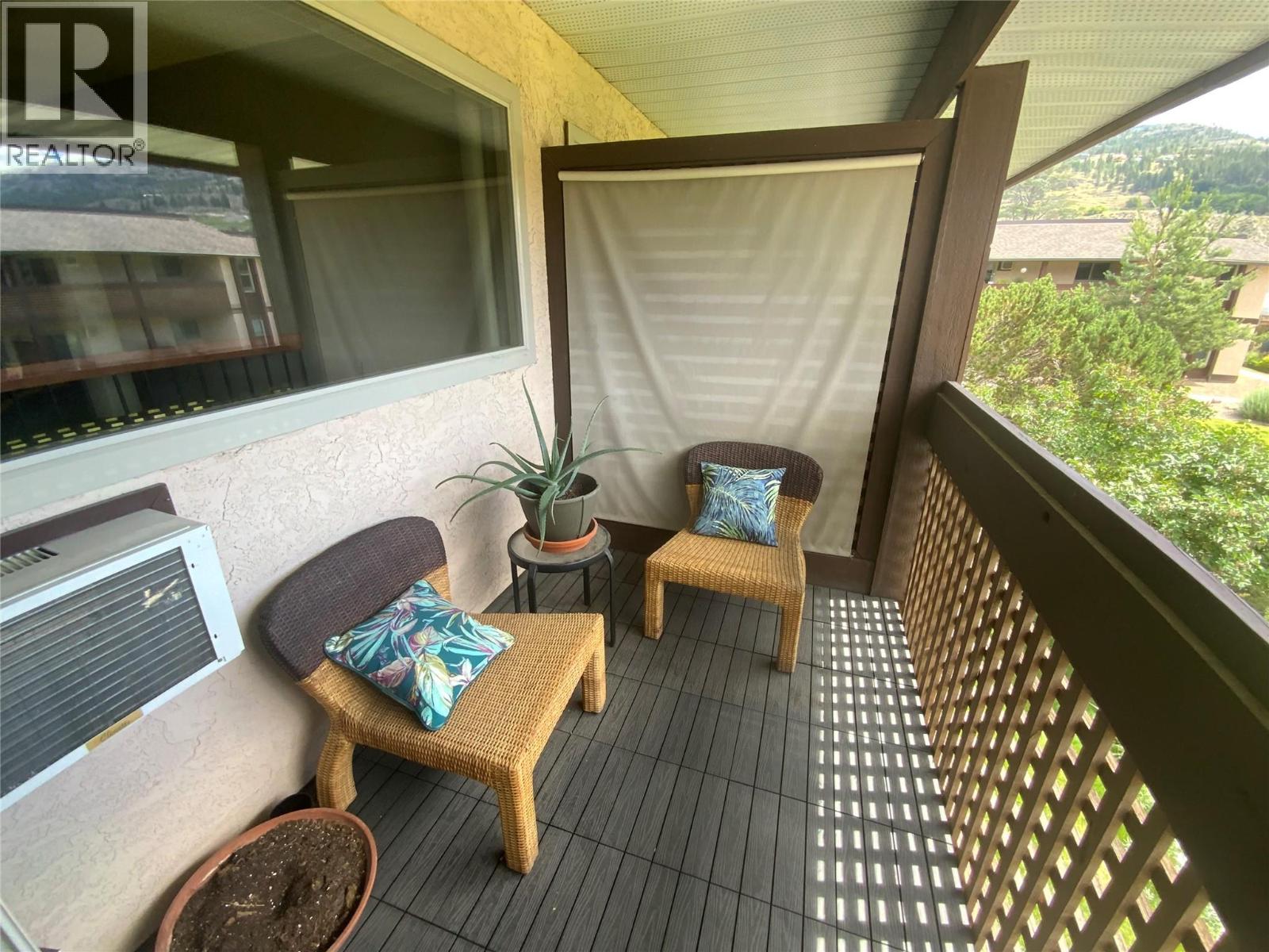 Unit 216 at Tiffany Gardens, 3140 Wilson Street, Penticton — covered upper balcony