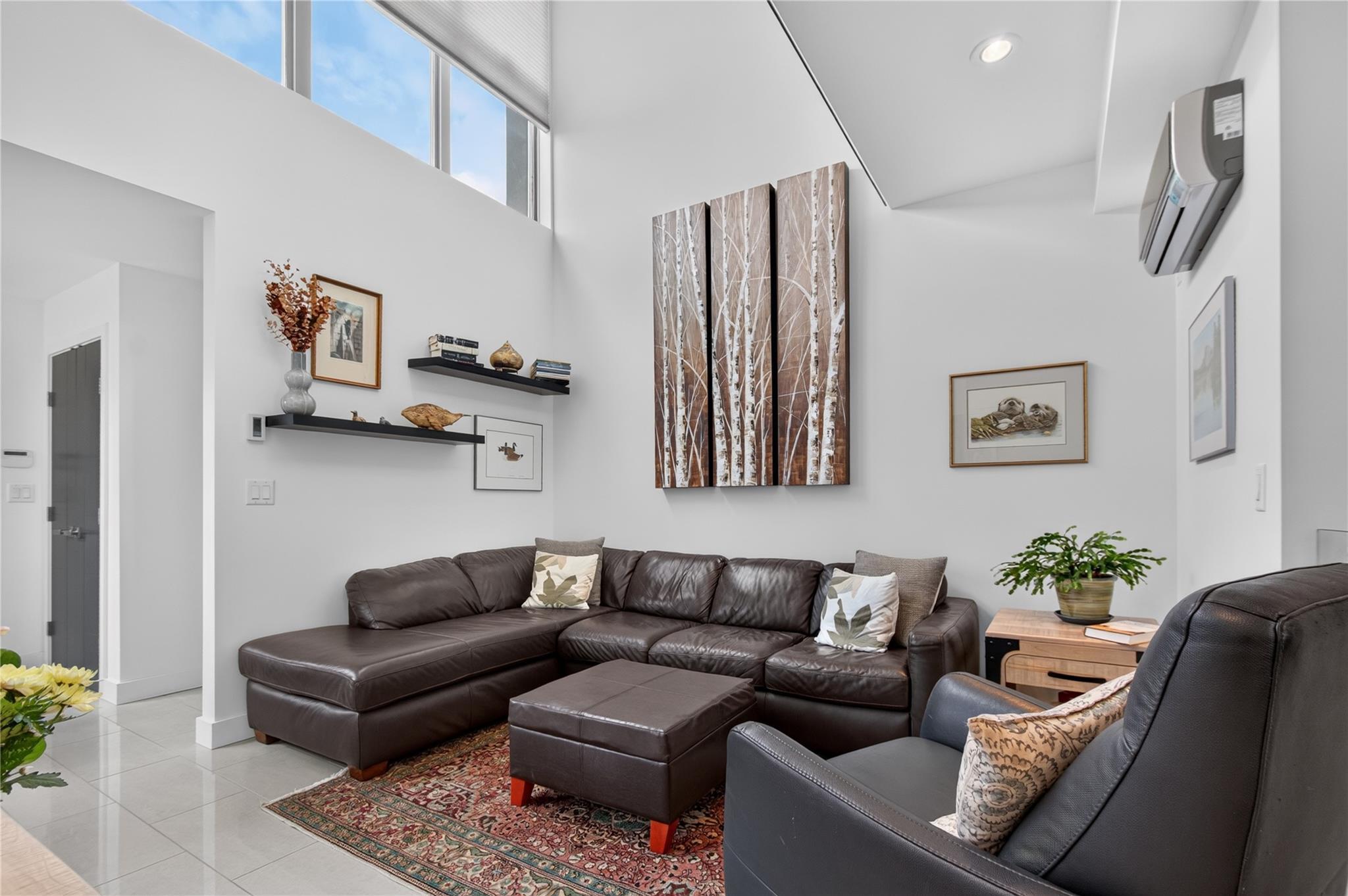 102-433 Churchill Avenue, Penticton — double-height living room with sectional seating