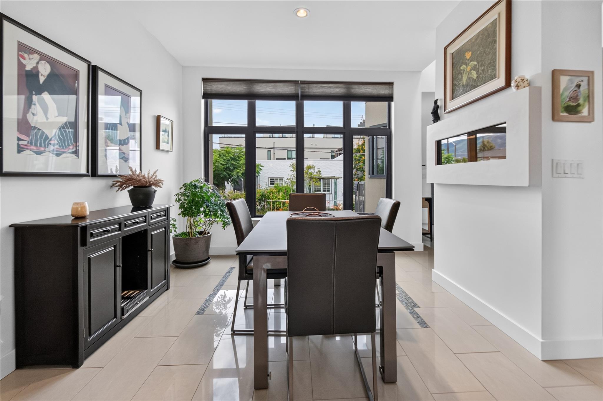 102-433 Churchill Avenue, Penticton — dining area with large windows and serving cabinetry
