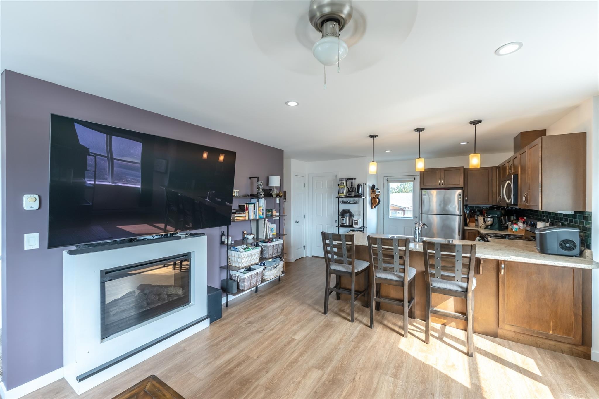 Open-concept living, dining and kitchen area in Unit 102.