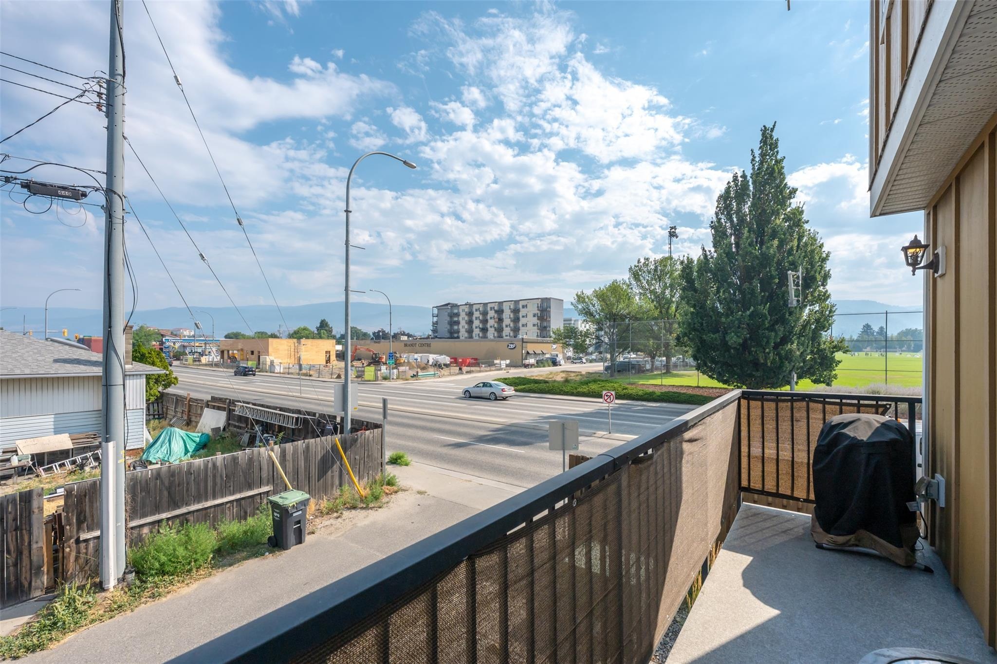 Balcony outlook toward nearby recreation fields and mountains.