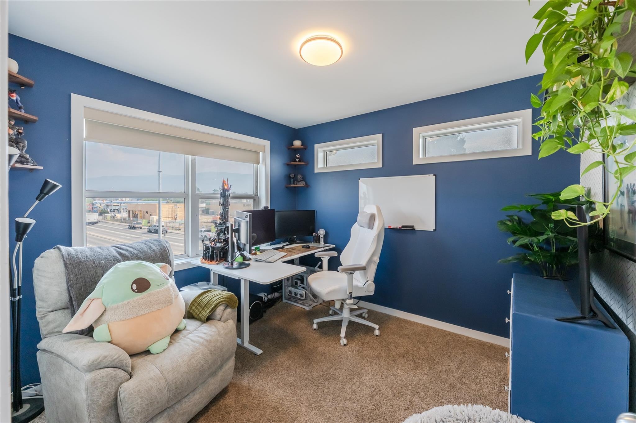 Flexible second bedroom arranged as a home office.