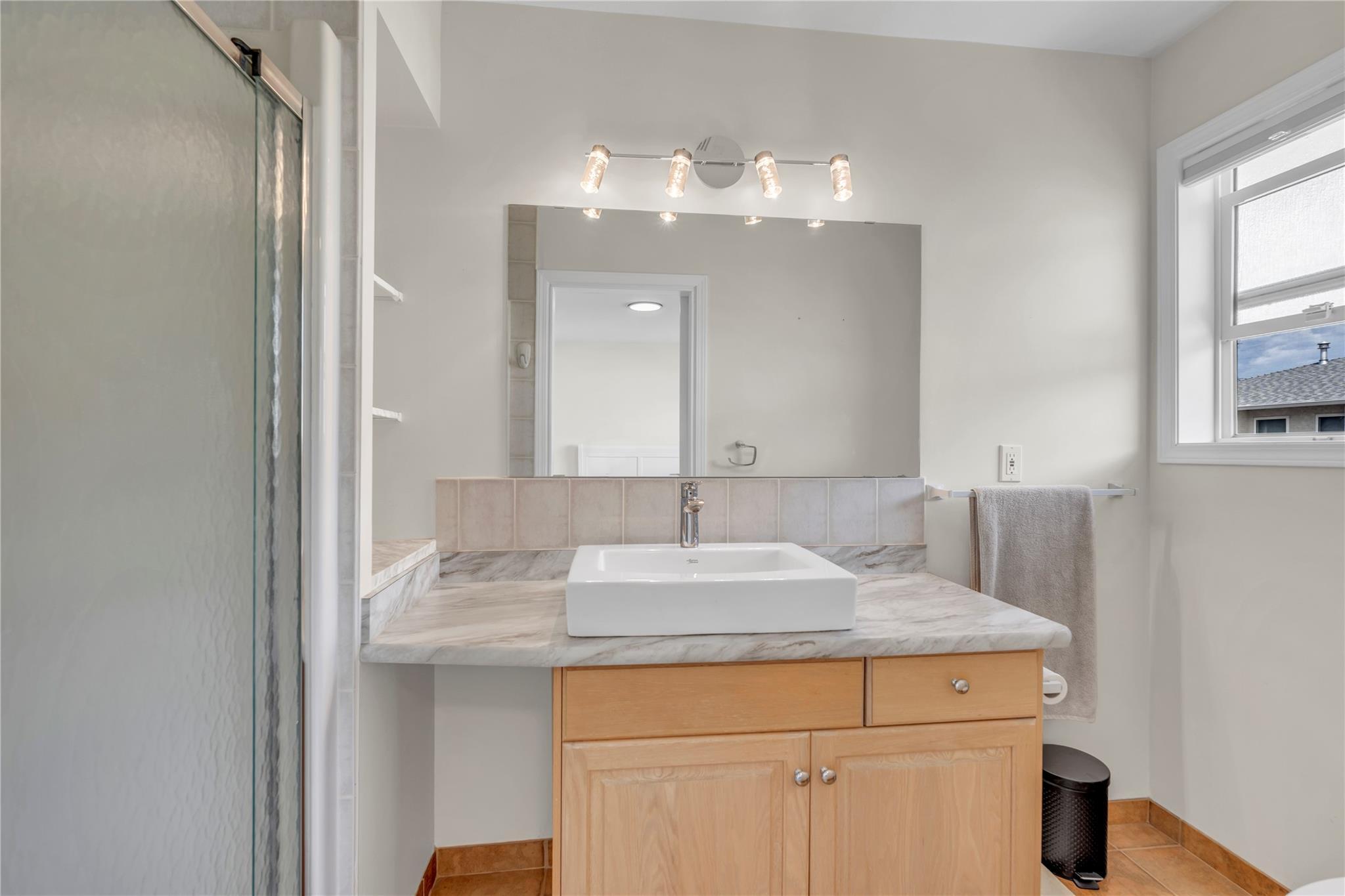 103 166 Green Avenue W, Penticton — bathroom with glass shower and updated vanity