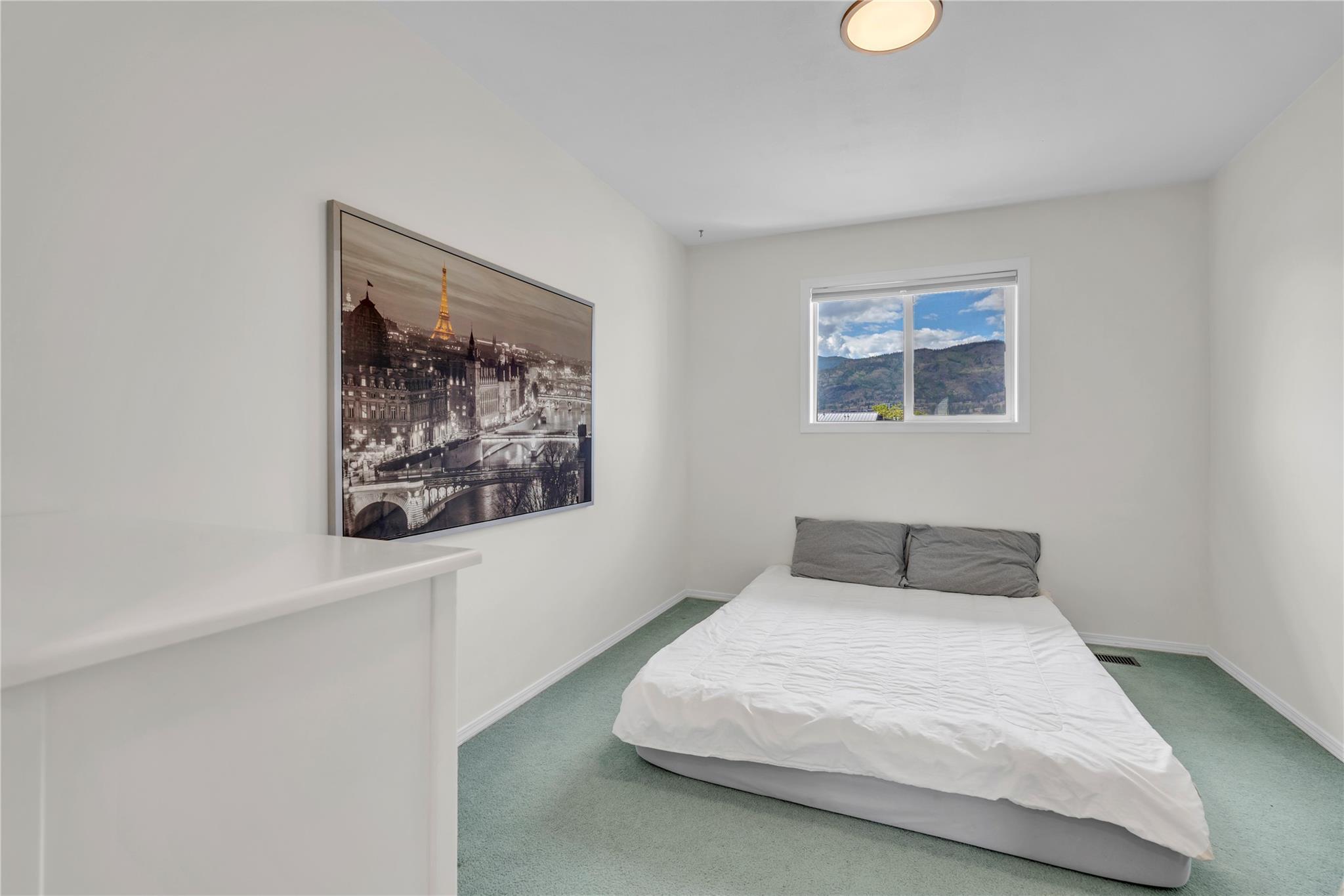 103 166 Green Avenue W, Penticton — secondary bedroom with mountain-facing window