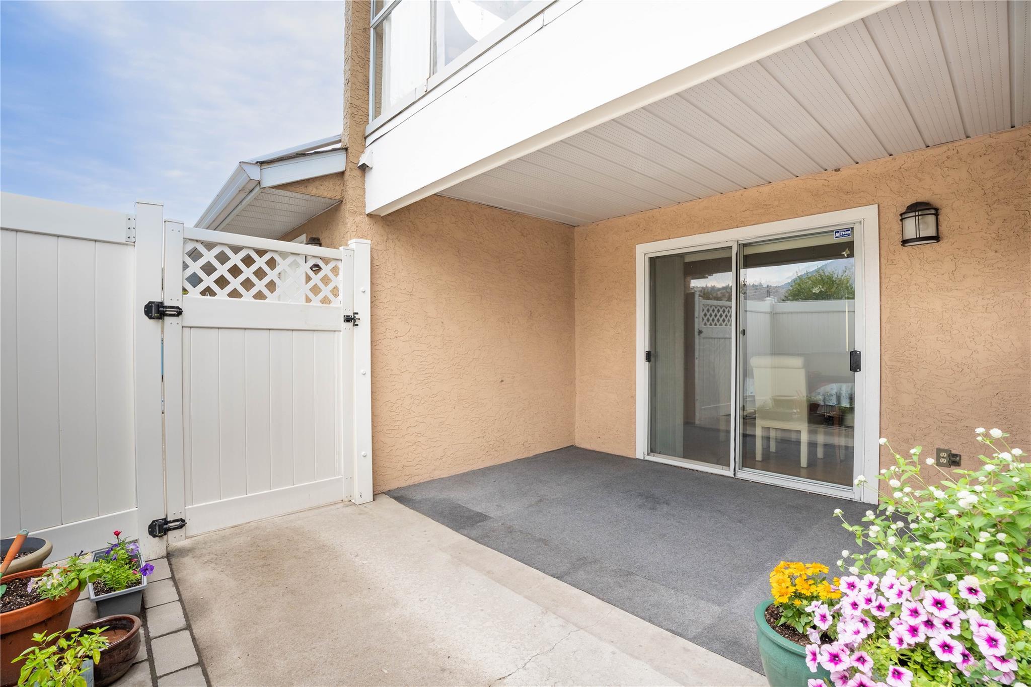 Private covered patio with sliding-door access at Unit 105 in Brandon Park.