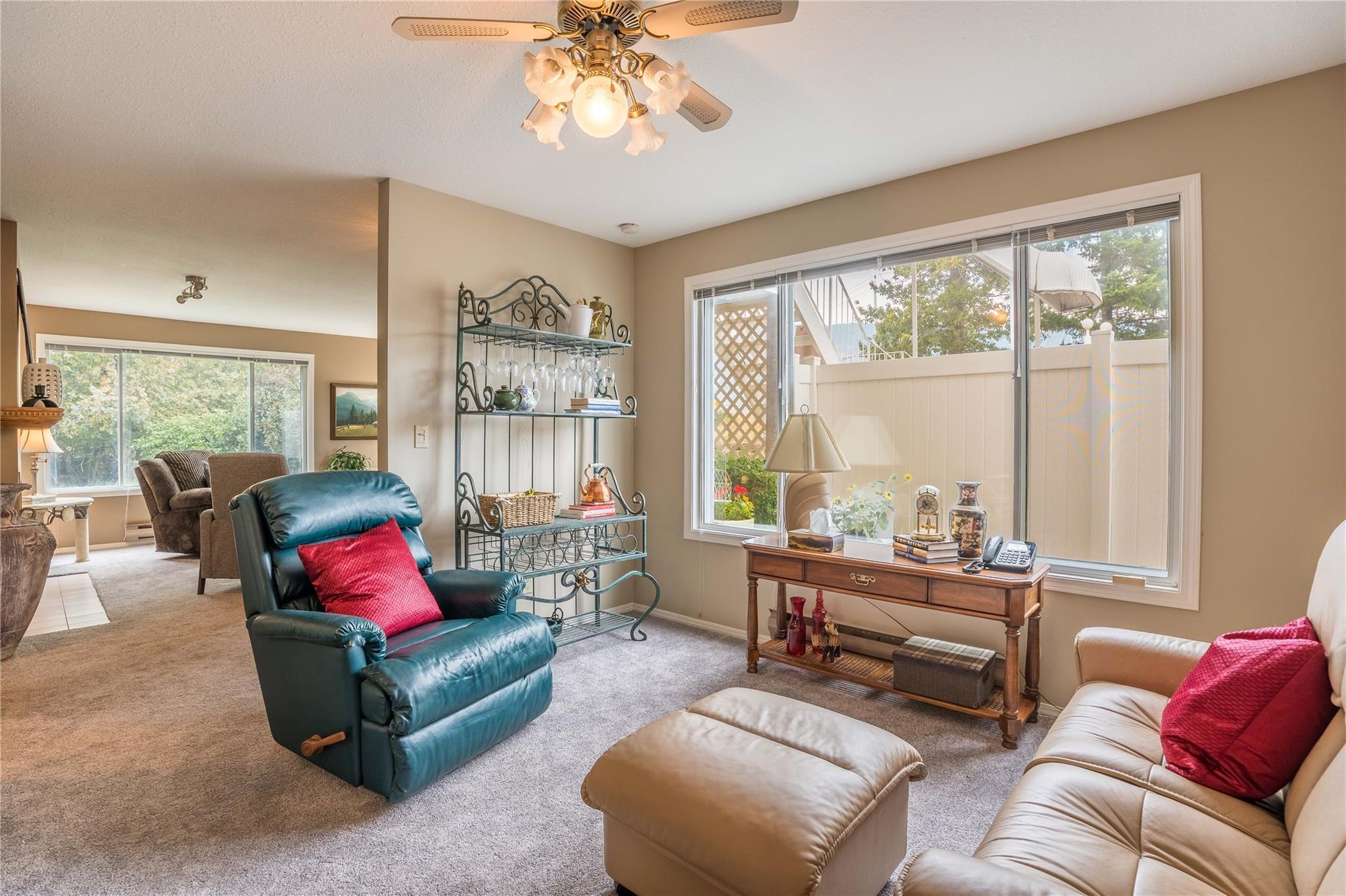 Bright family room with large corner windows in Unit 105.