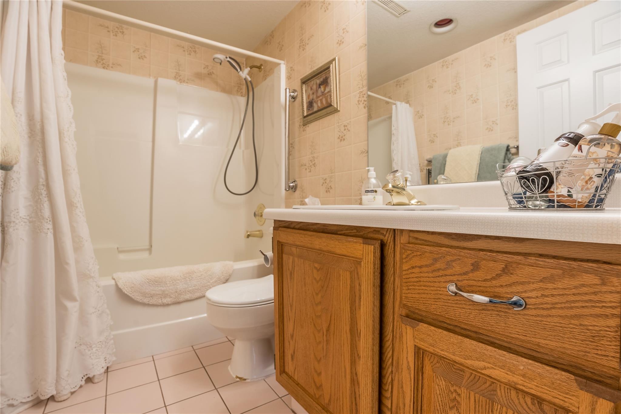 Four-piece bathroom with tub-shower in Unit 105.