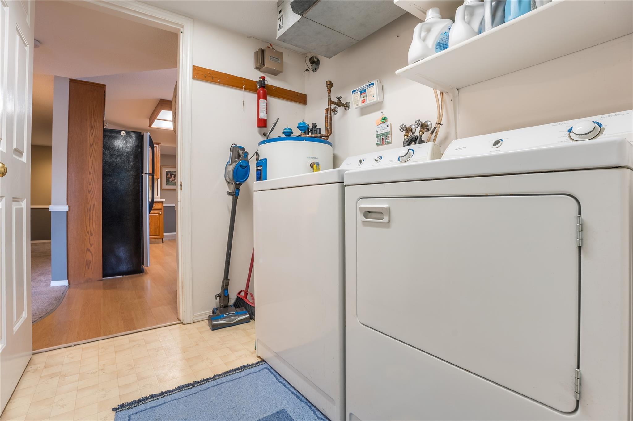 In-suite laundry and utility area in Unit 105.