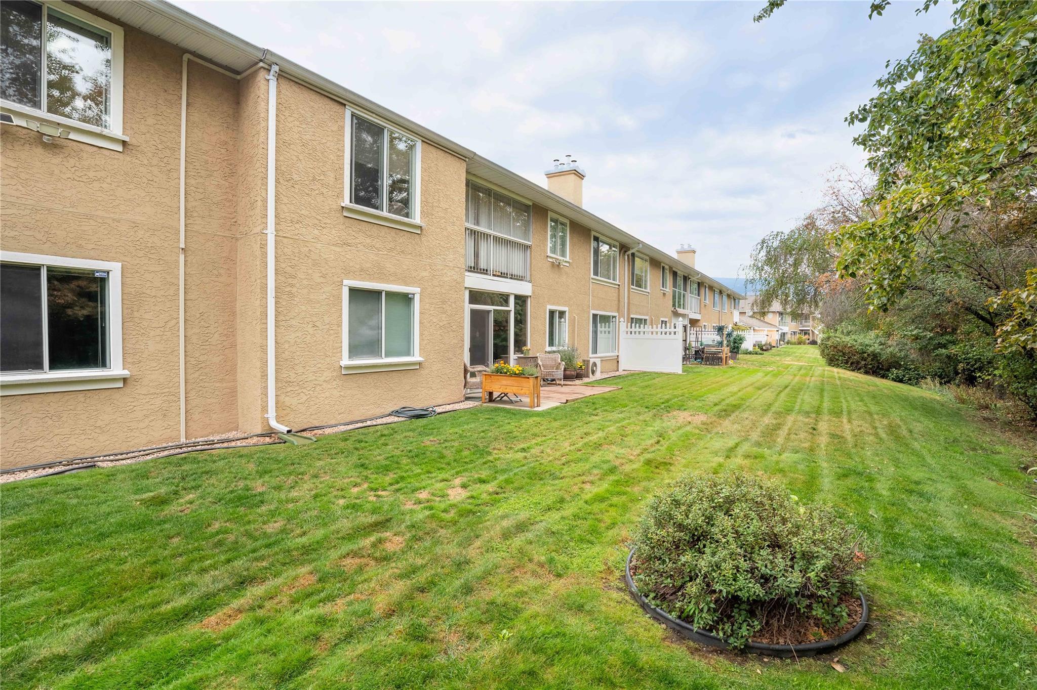 Landscaped common green space behind Brandon Park townhomes in Penticton.