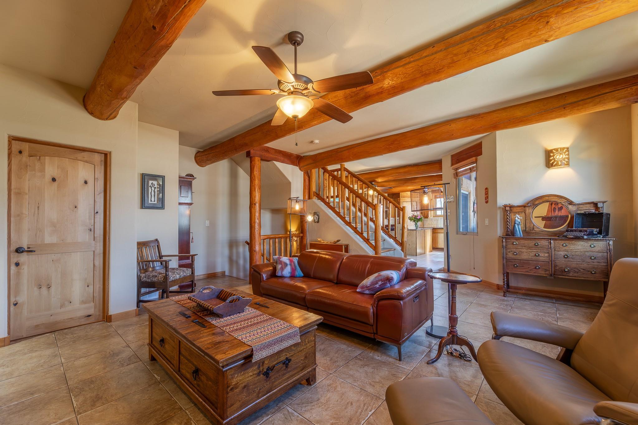 Living room with exposed wood beams and fireplace at 105-483 Maurice Street.