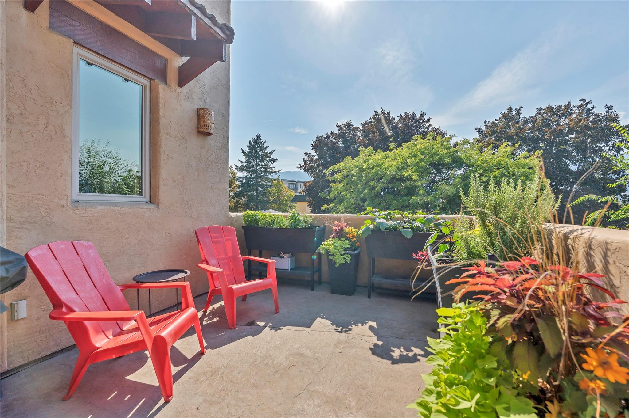 Private entry courtyard with seating and landscaping at Unit 105.