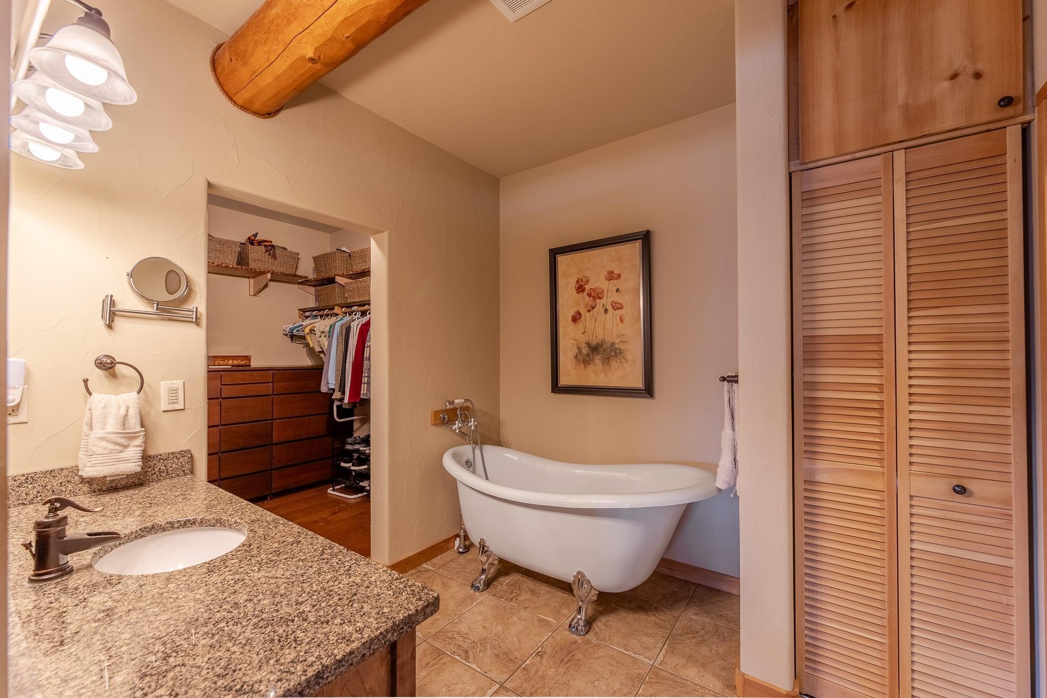 Ensuite bathroom with clawfoot tub and vanity at Unit 105.