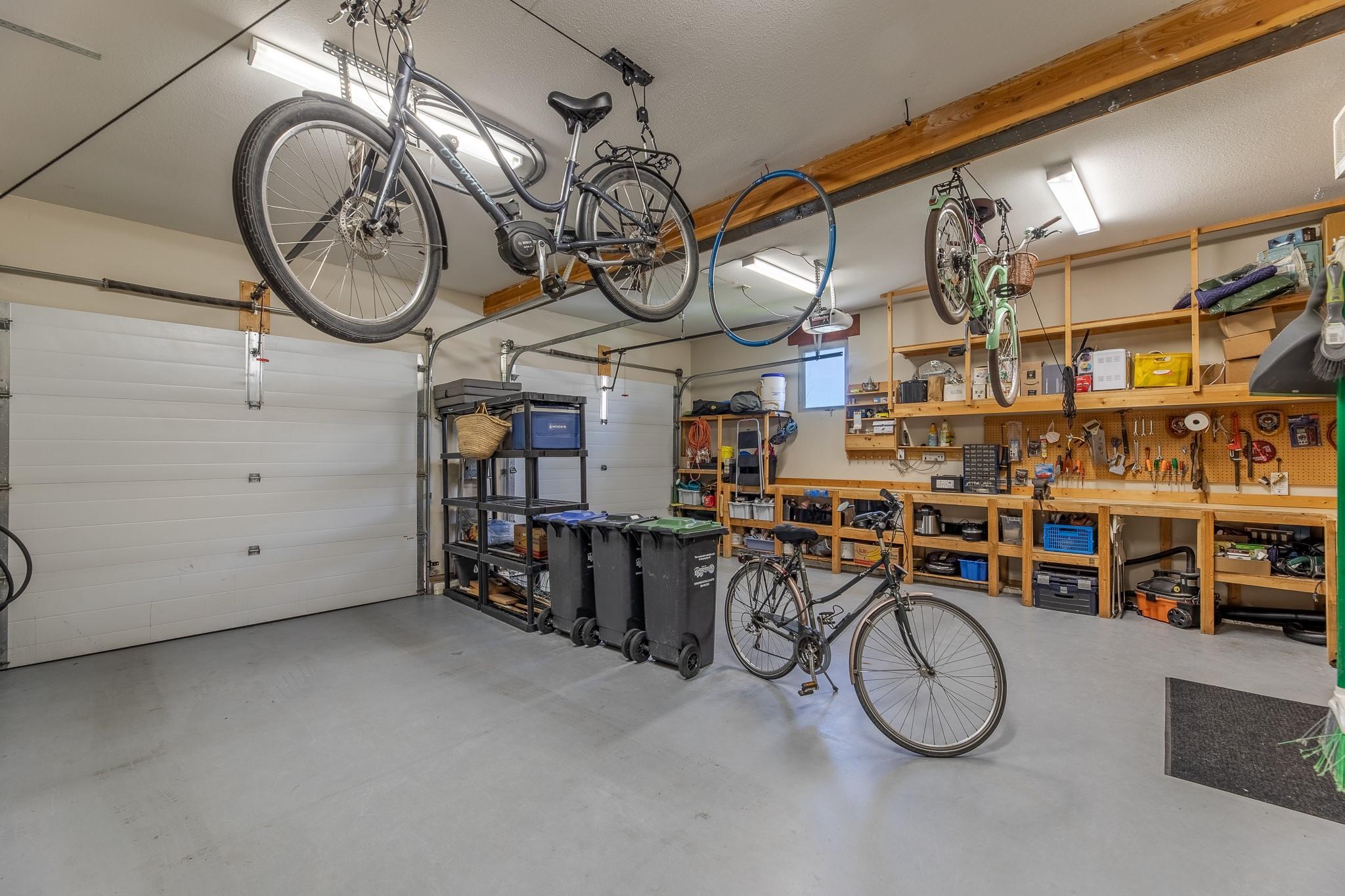Oversized double garage with storage and workshop space at Unit 105.