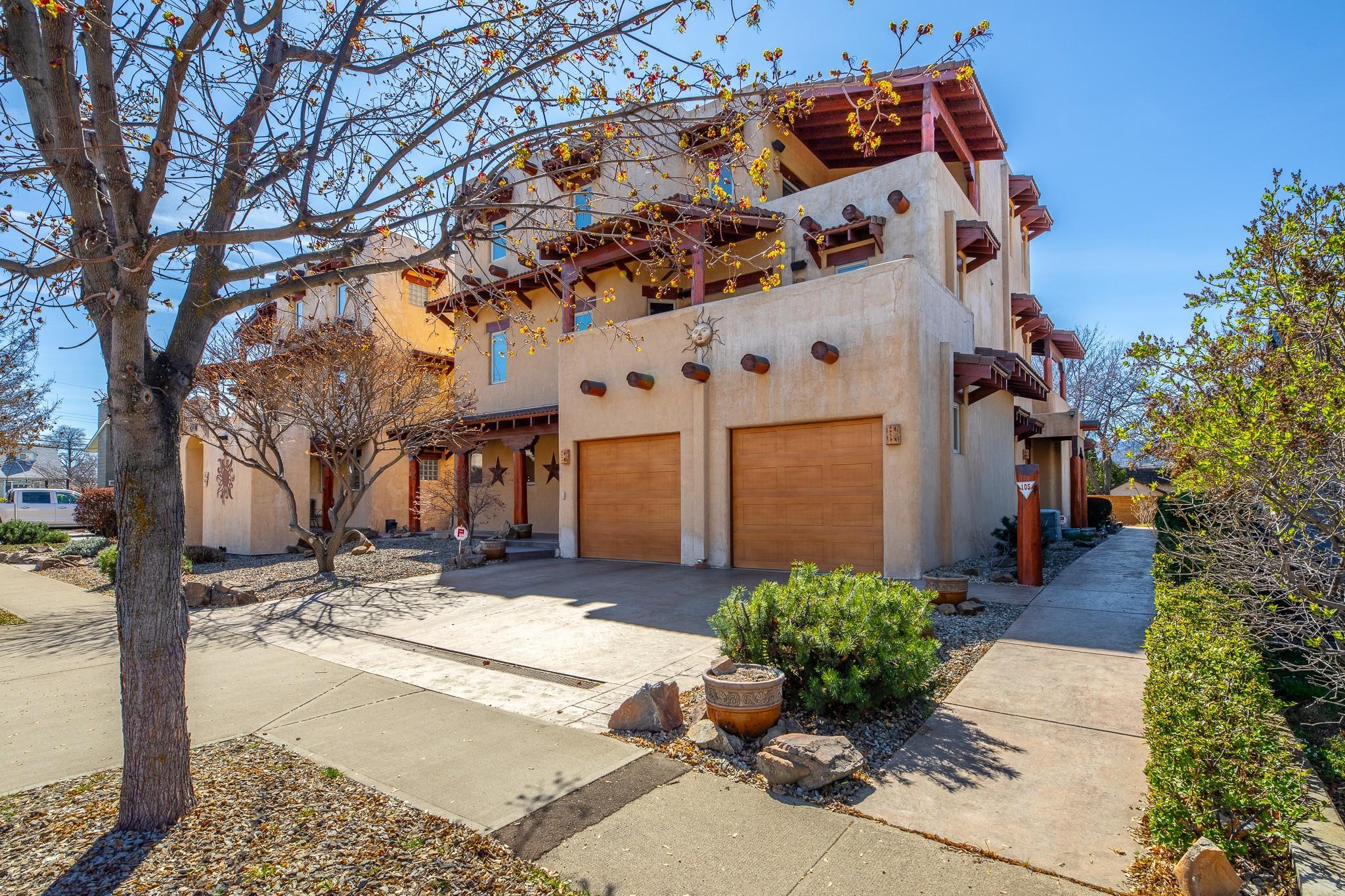 Street-side exterior view of the adobe-style townhome at 105-483 Maurice Street.