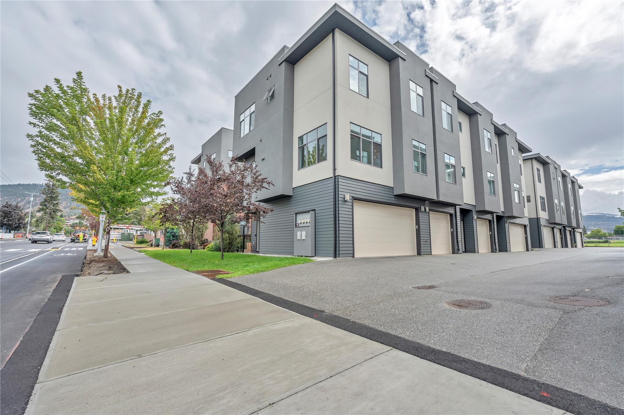 Street-side exterior and attached garages at Uptown townhomes in Penticton.