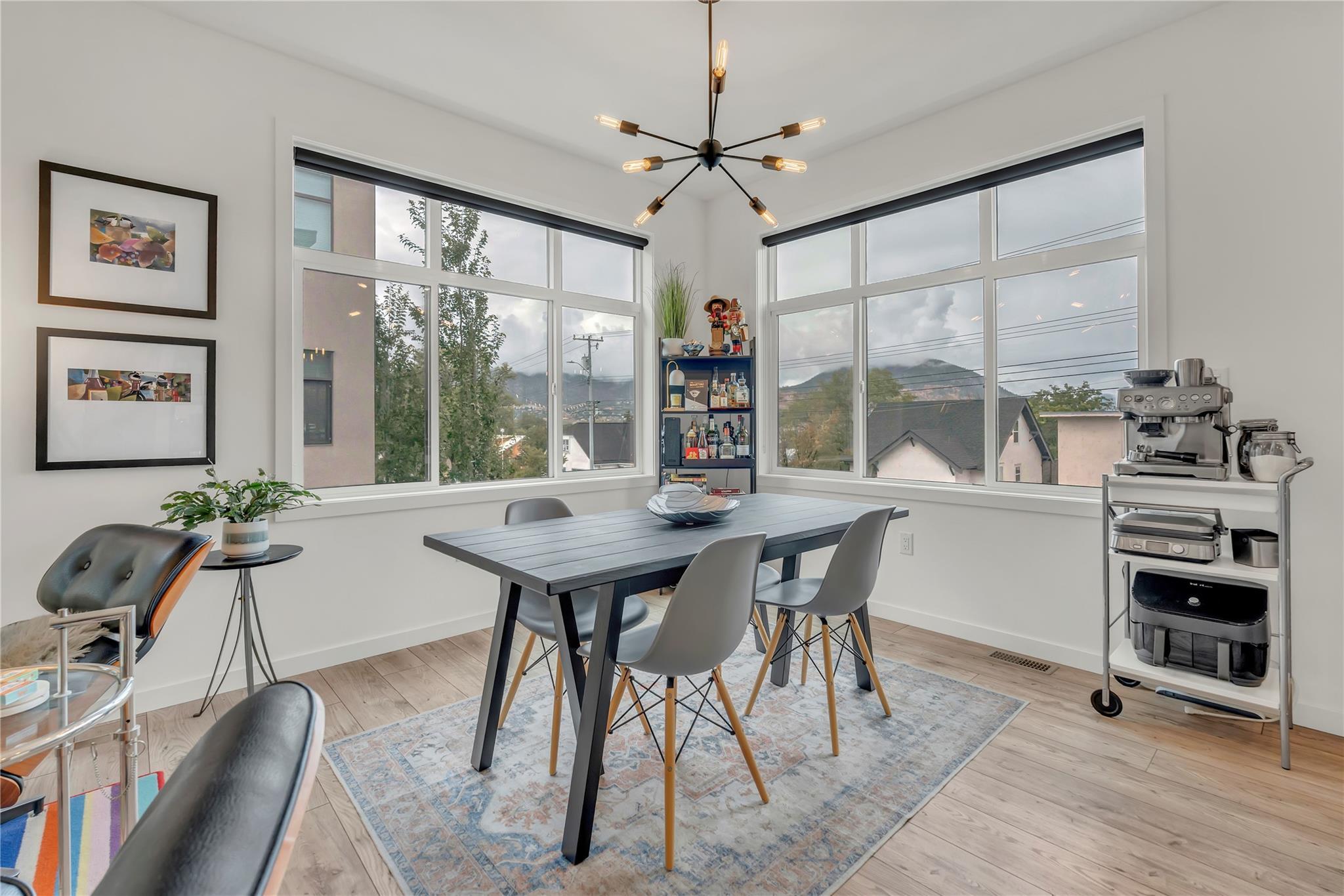 Bright dining area with corner windows in Unit 115.