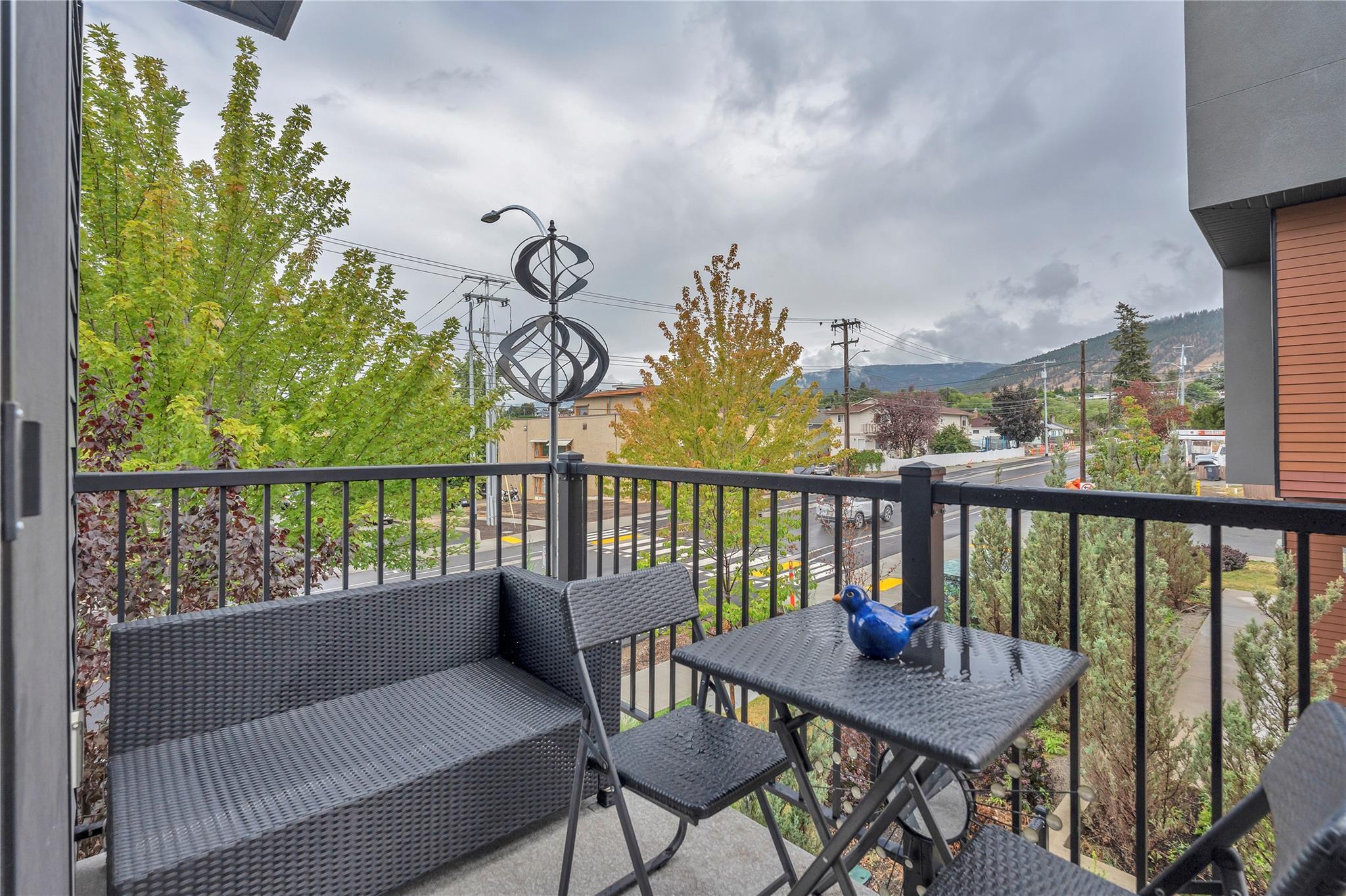 Private upper patio with neighbourhood and mountain outlook at Unit 115.