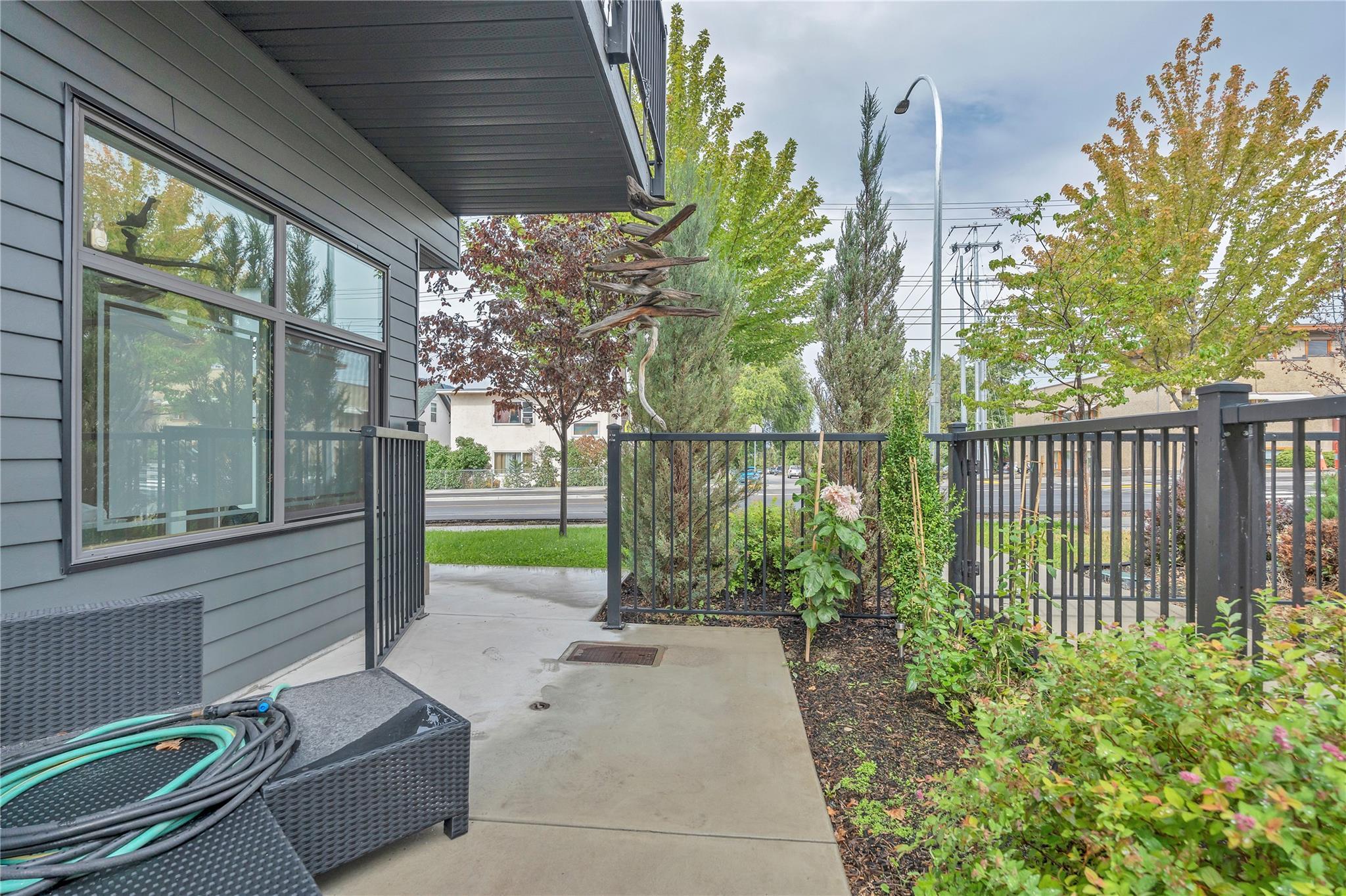 Fenced ground-level garden and patio area at Unit 115.