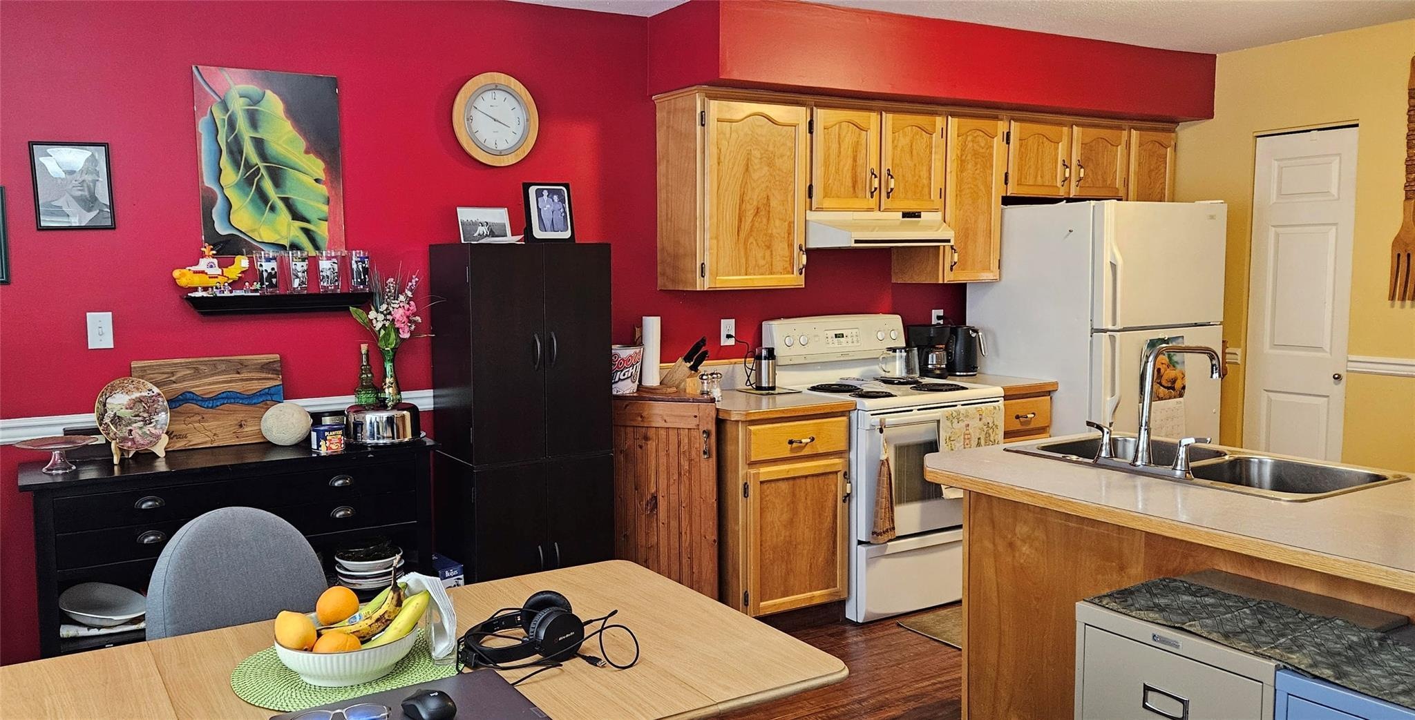 Open kitchen and dining area with wood cabinetry at Unit 119.