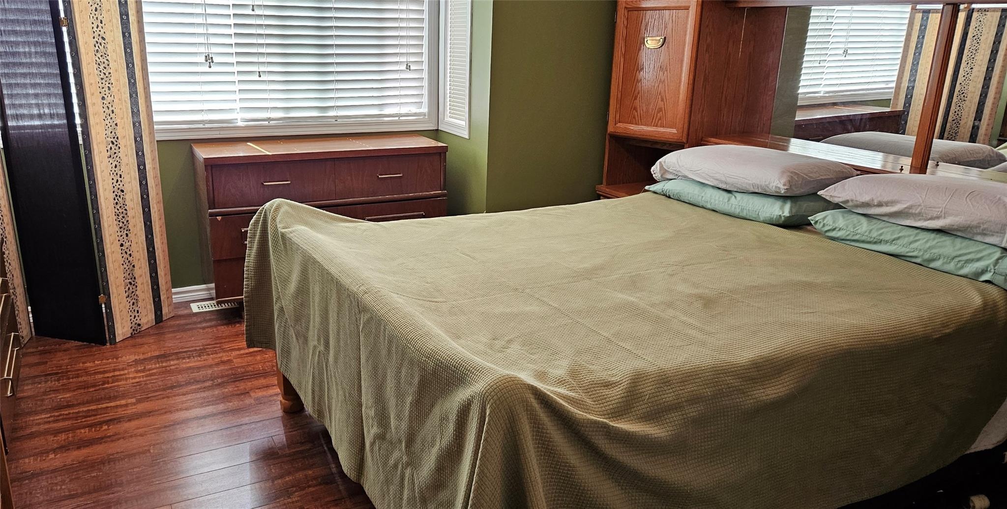 Second bedroom with wood-look flooring at Unit 119.