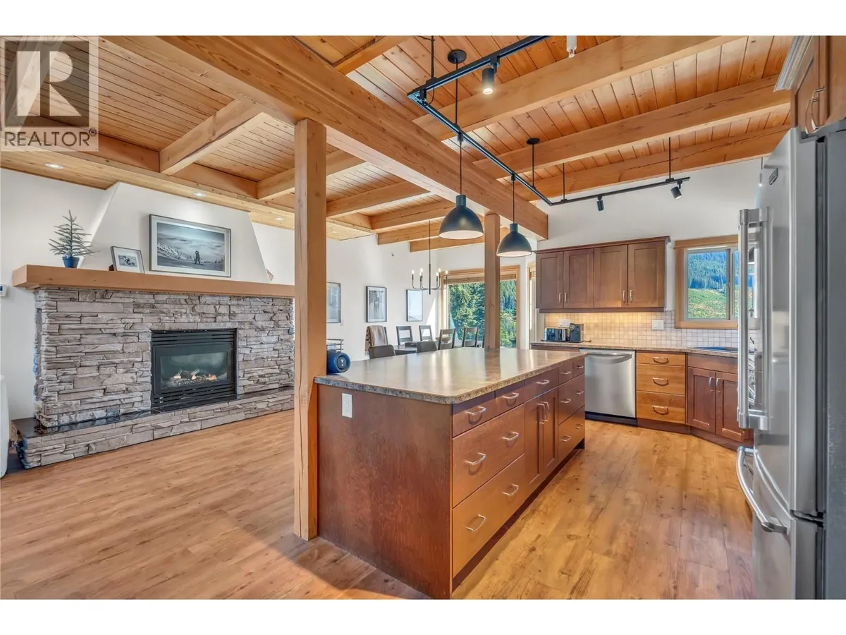 Open-concept kitchen with large island and stainless appliances at 14-306 Creekview Road.
