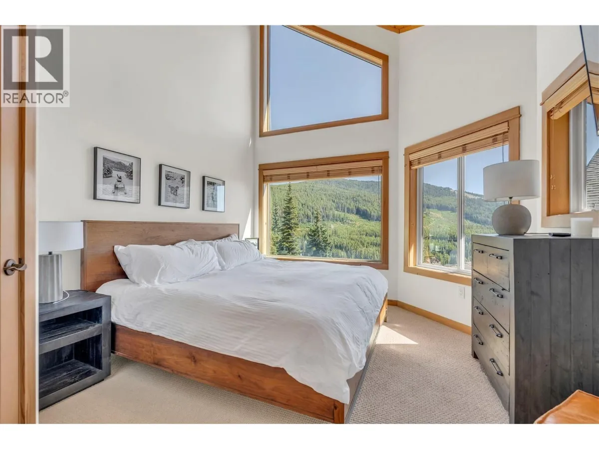 Bedroom with wood finishes at 14-306 Creekview Road, Apex Mountain.