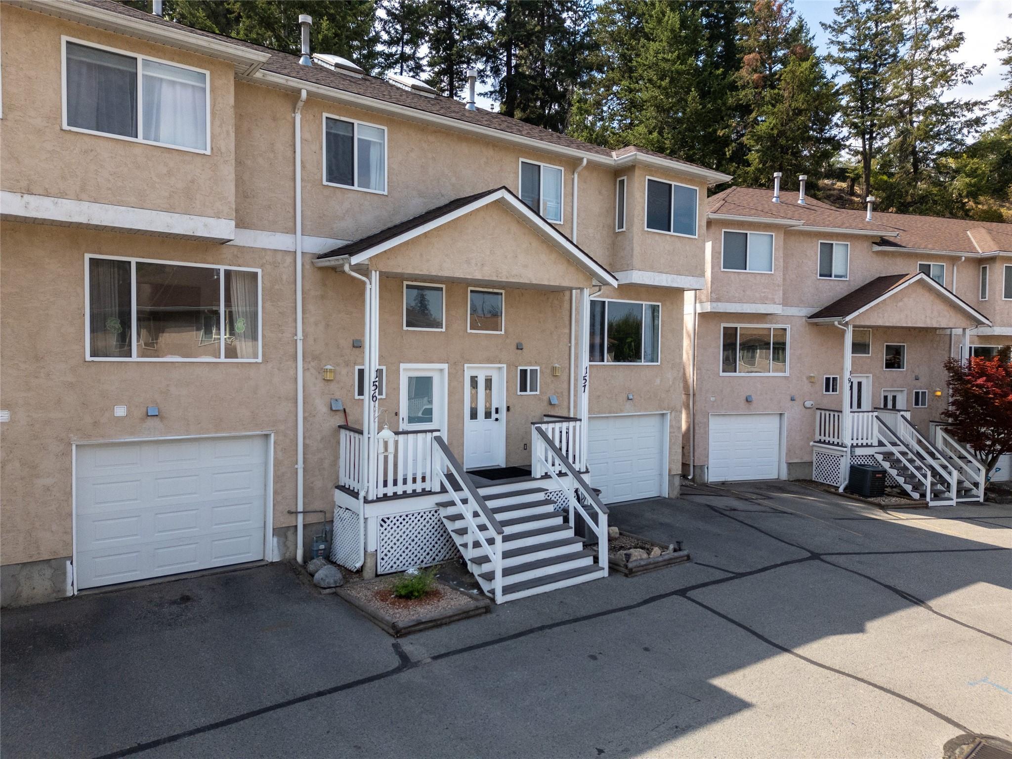 Front exterior and attached garage of Unit 156 at Cascade Gardens in Penticton.