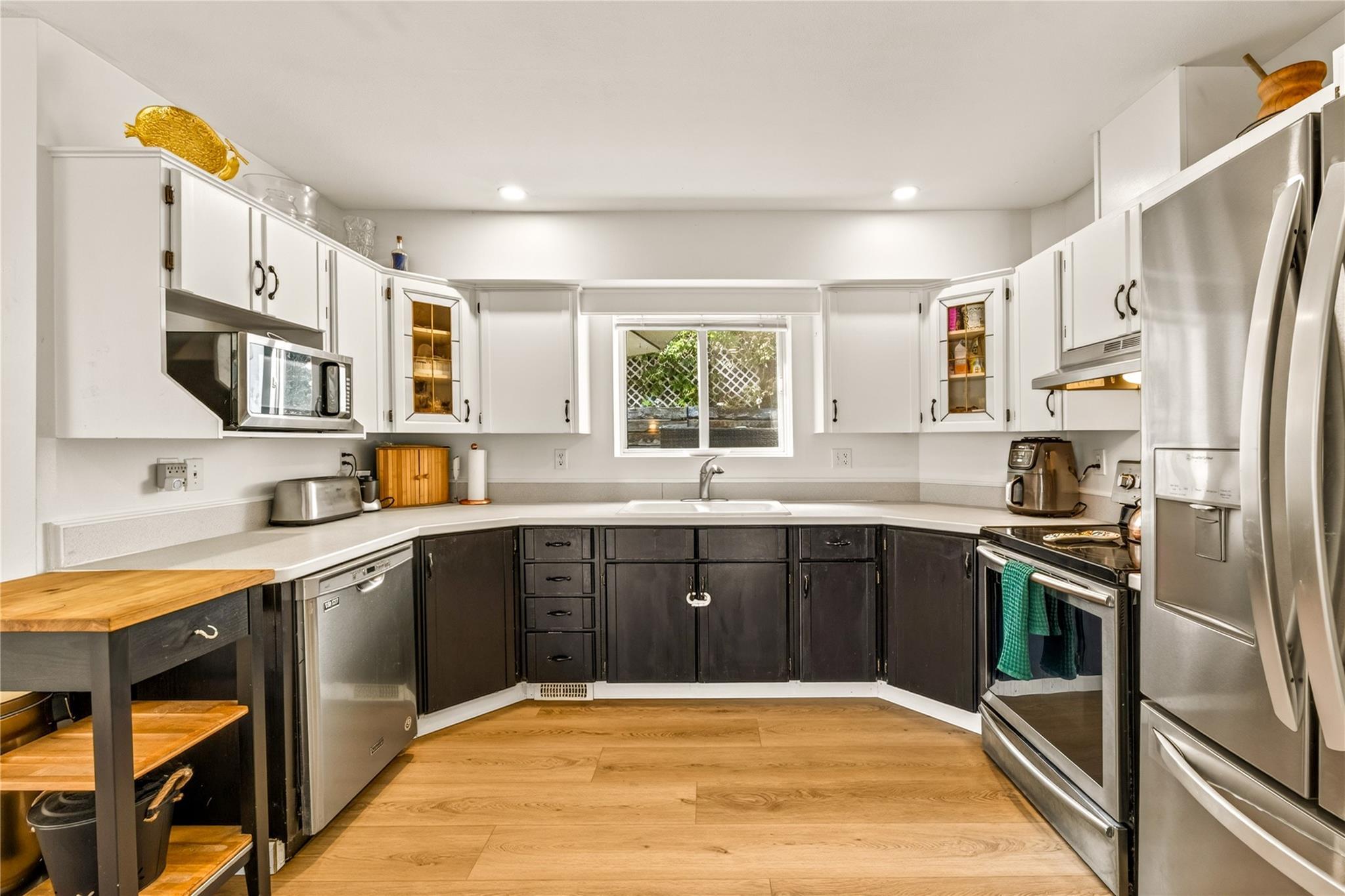 Updated two-tone kitchen with stainless appliances in Unit 156.