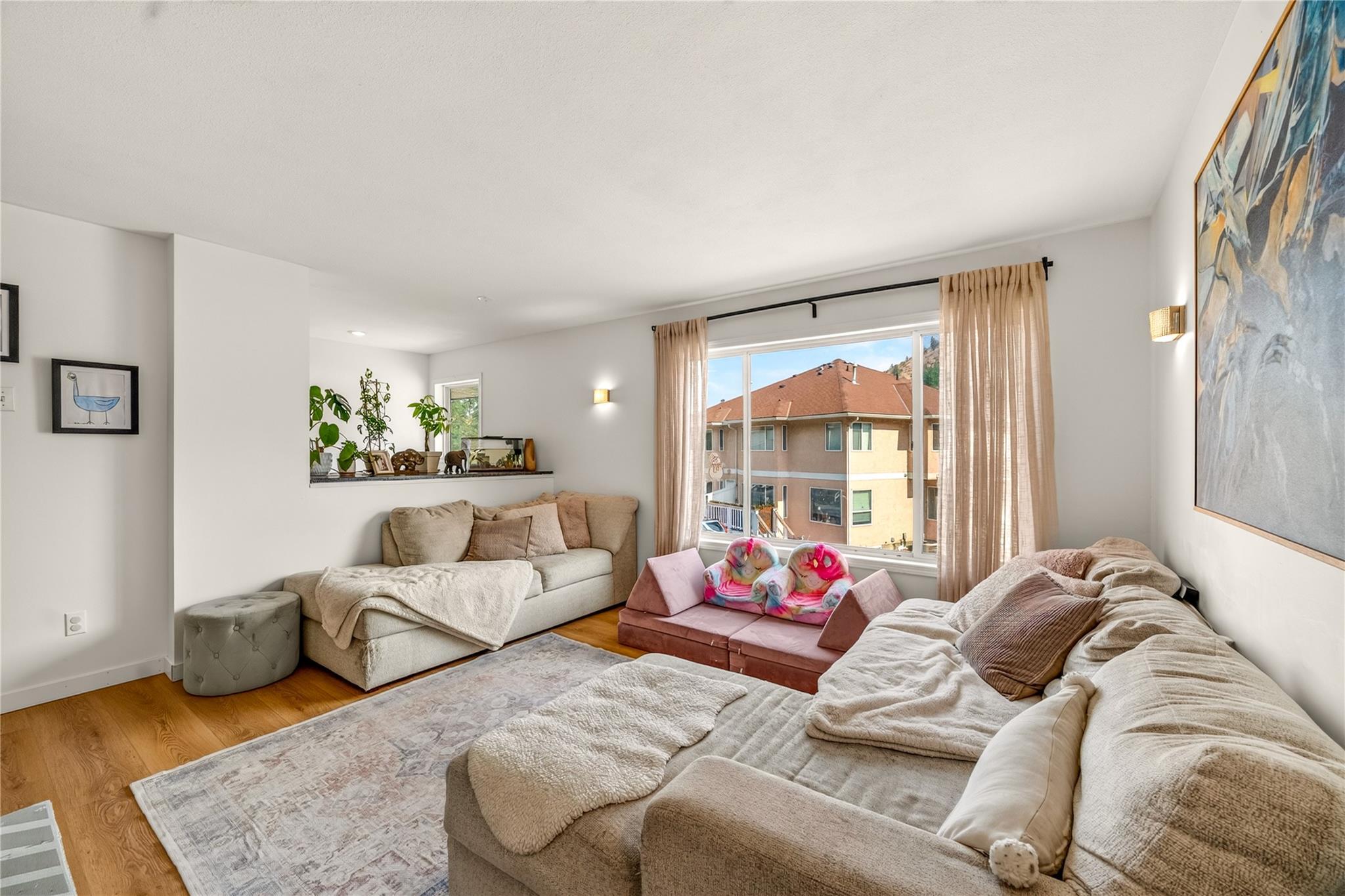 Bright living room with fireplace and large windows in Unit 156.