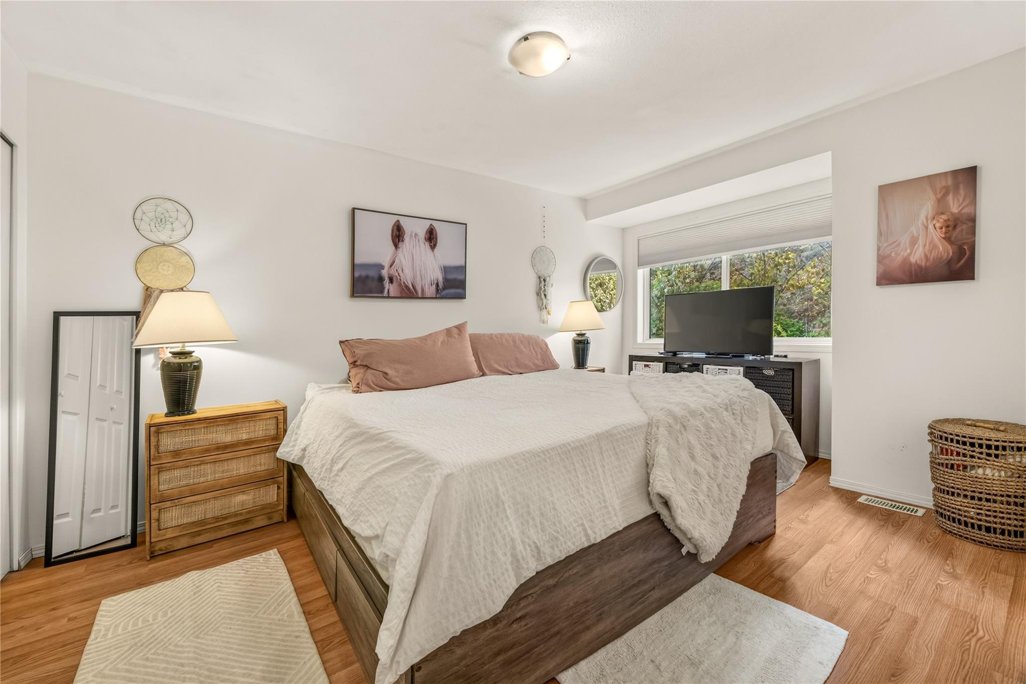 Primary bedroom with large window in Unit 156.