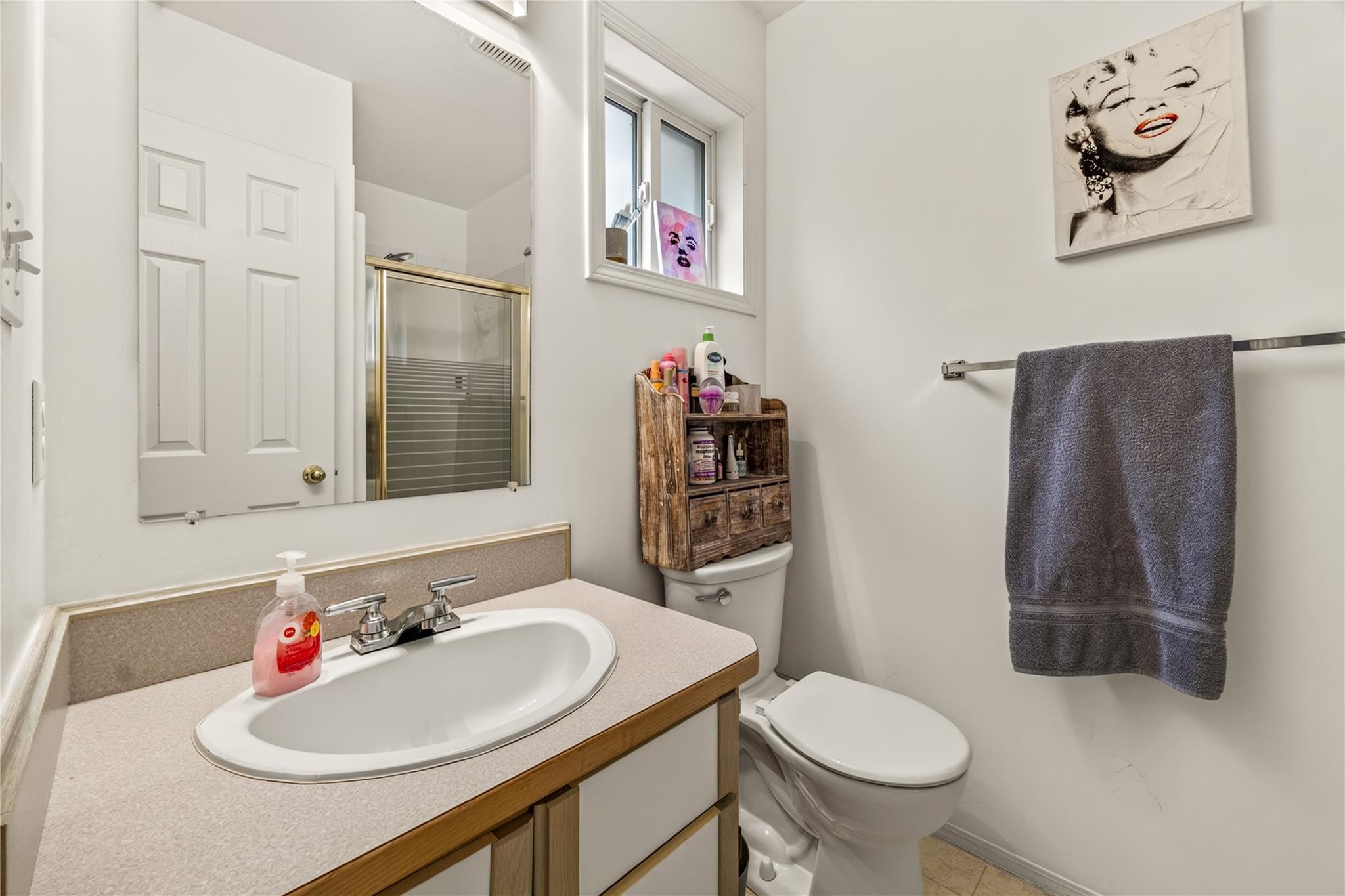 Bathroom vanity and tub-shower in Unit 156.
