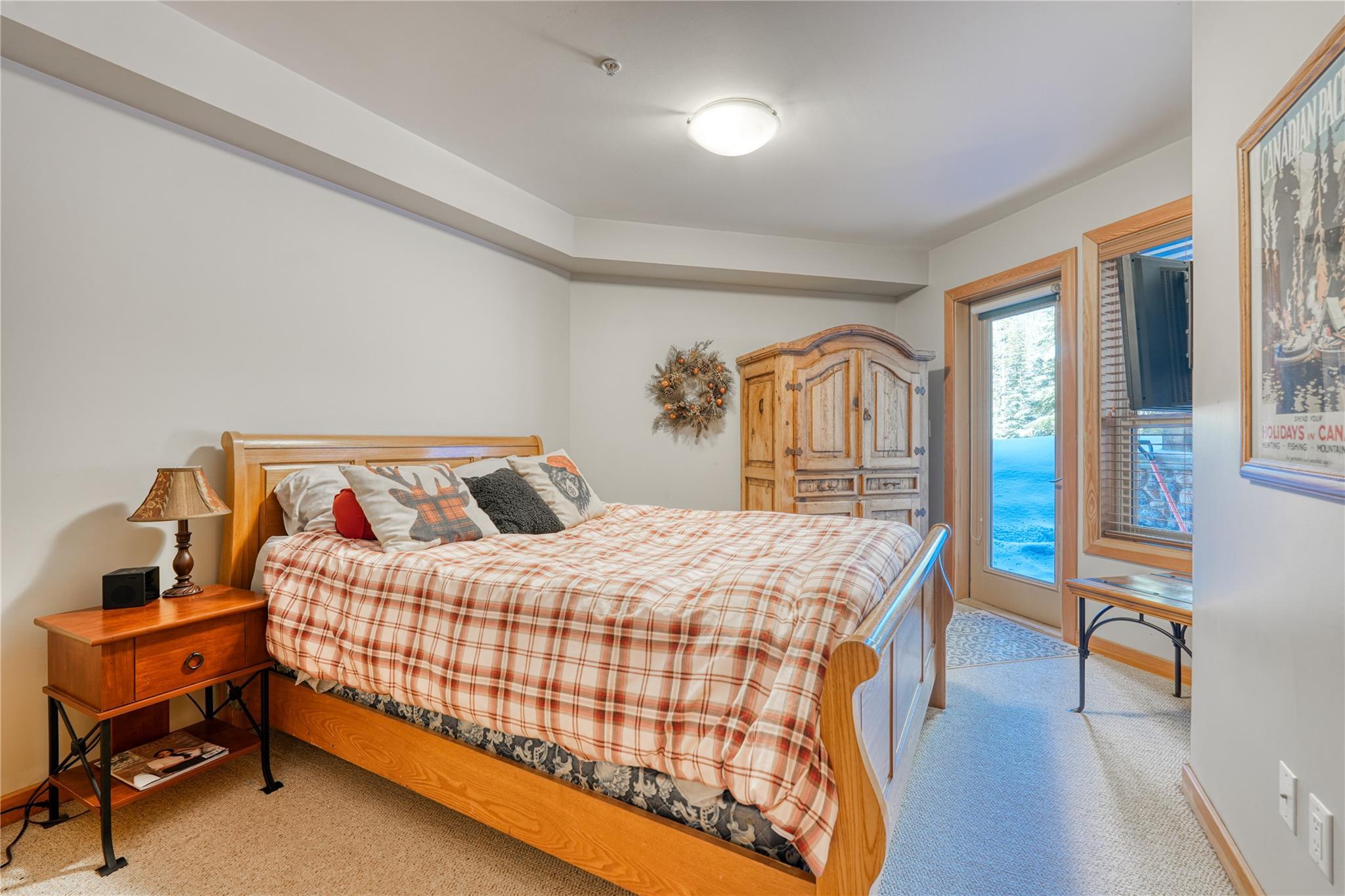 Bedroom with mountain-home furnishings in Unit 3 at 360 Strayhorse Road.